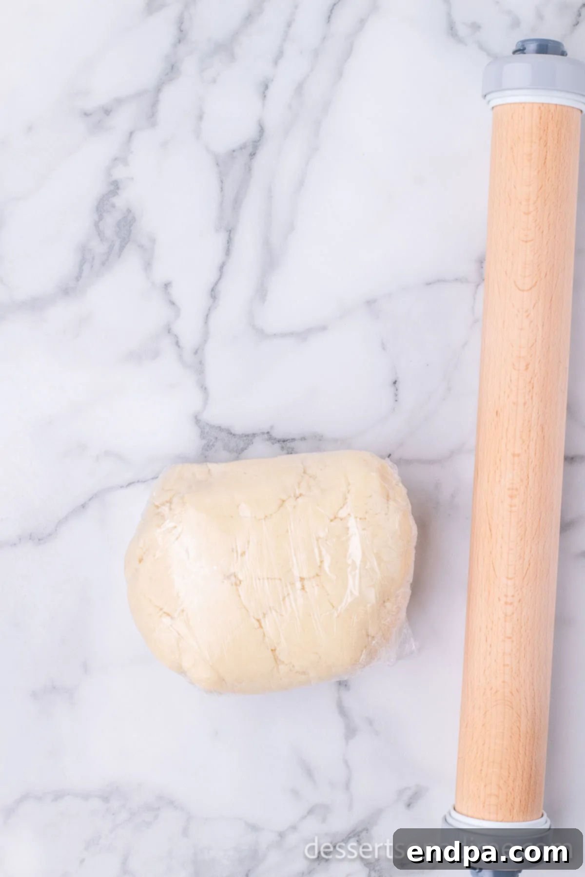 Hoppy Easter Cookie Creations 7 A ball of sugar cookie dough wrapped tightly in plastic wrap, ready for chilling.