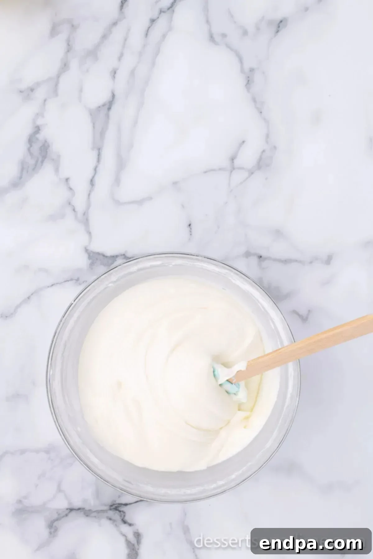Decadent Strawberry Shortcake Cheesecake 8 Granulated sugar and cornstarch added to the cheesecake mixture in a mixing bowl.