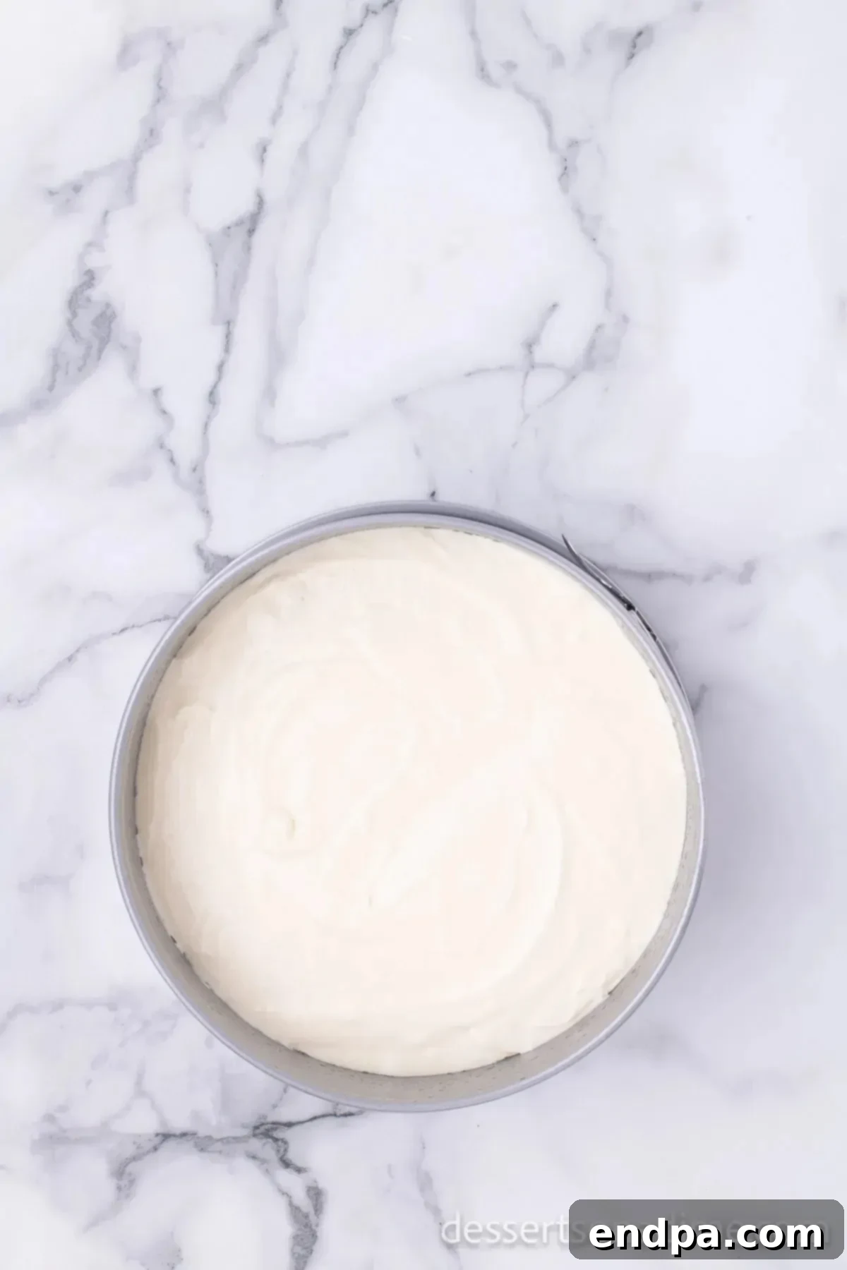 Decadent Strawberry Shortcake Cheesecake 9 Cheesecake batter being poured into a springform pan.