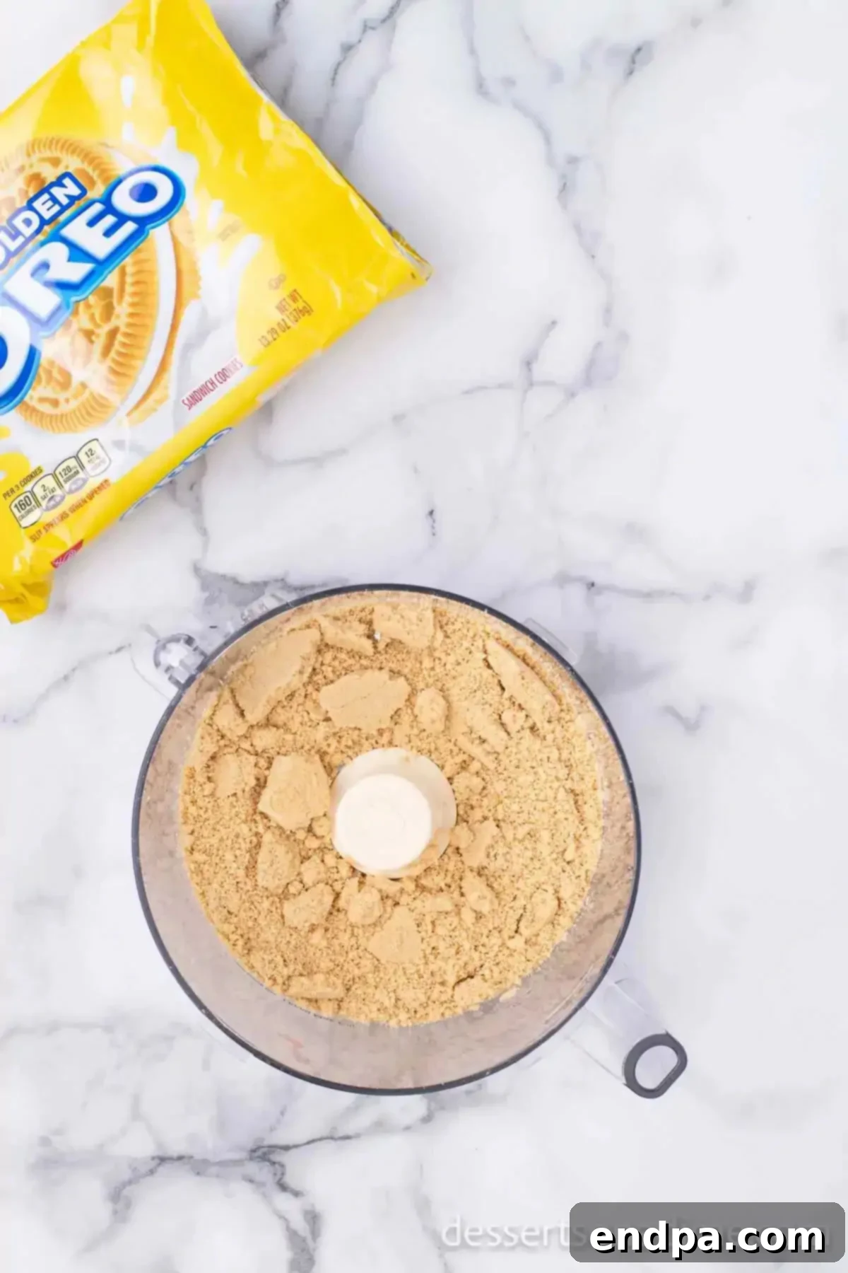 Decadent Strawberry Shortcake Cheesecake 10 Golden Oreo cookies being crushed in a food processor.