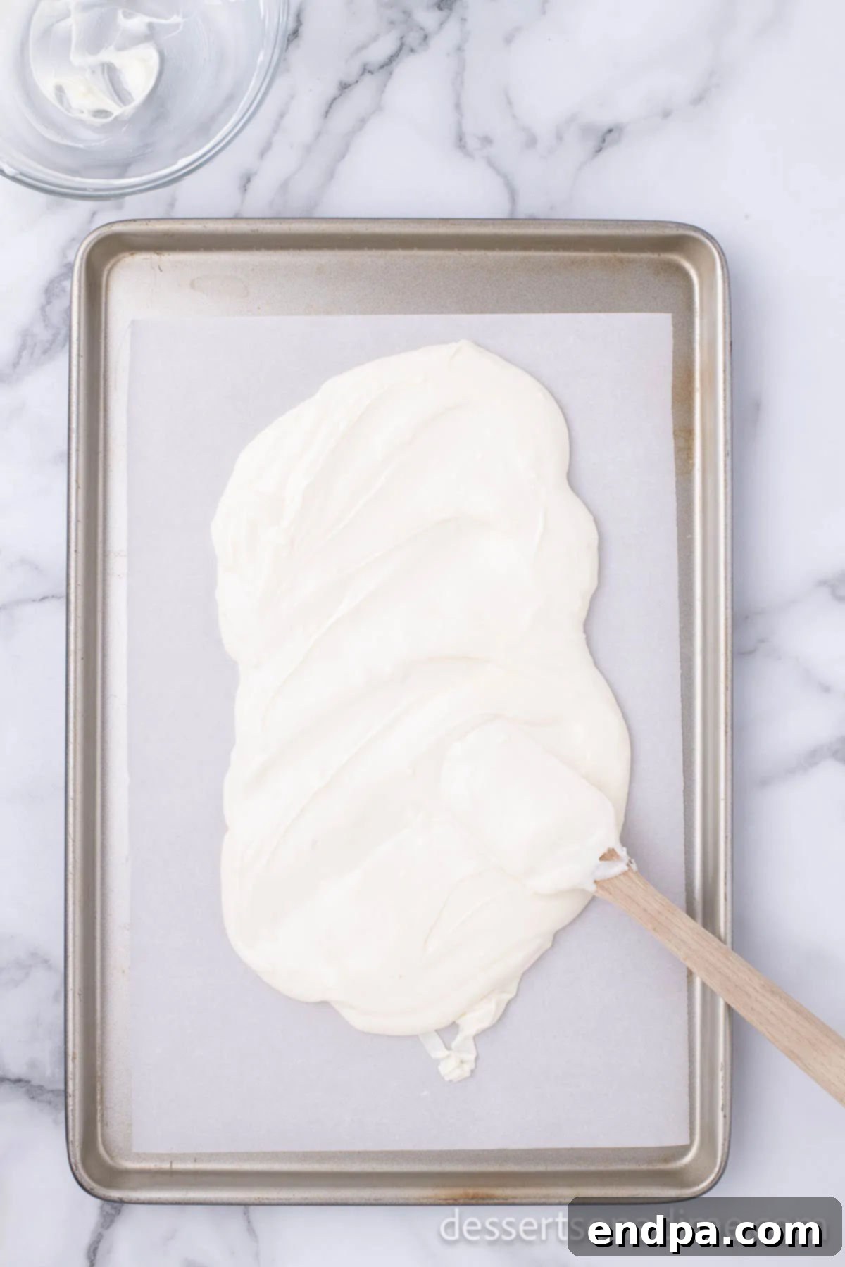 Melted chocolate spread on baking sheet. 
