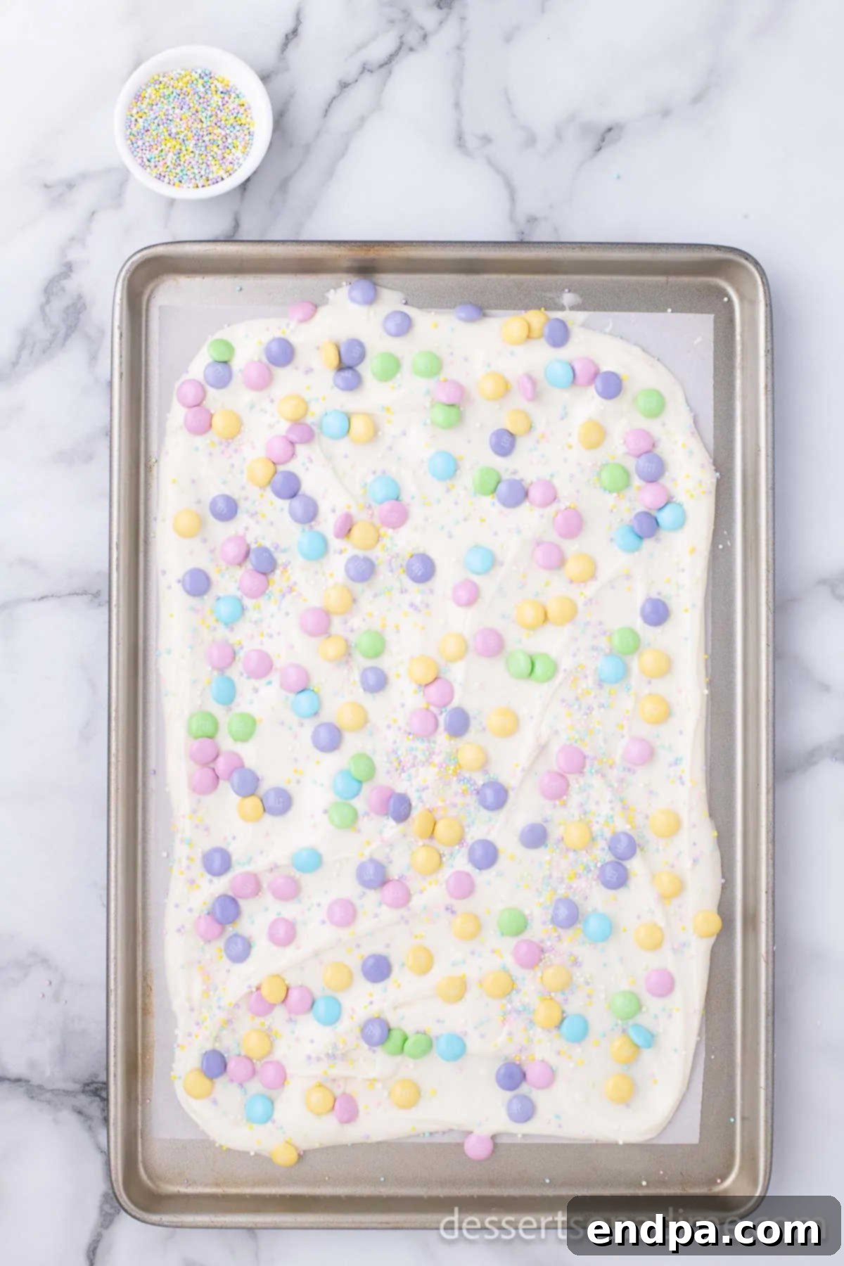 Candy sprinkled on top of melted candy. 