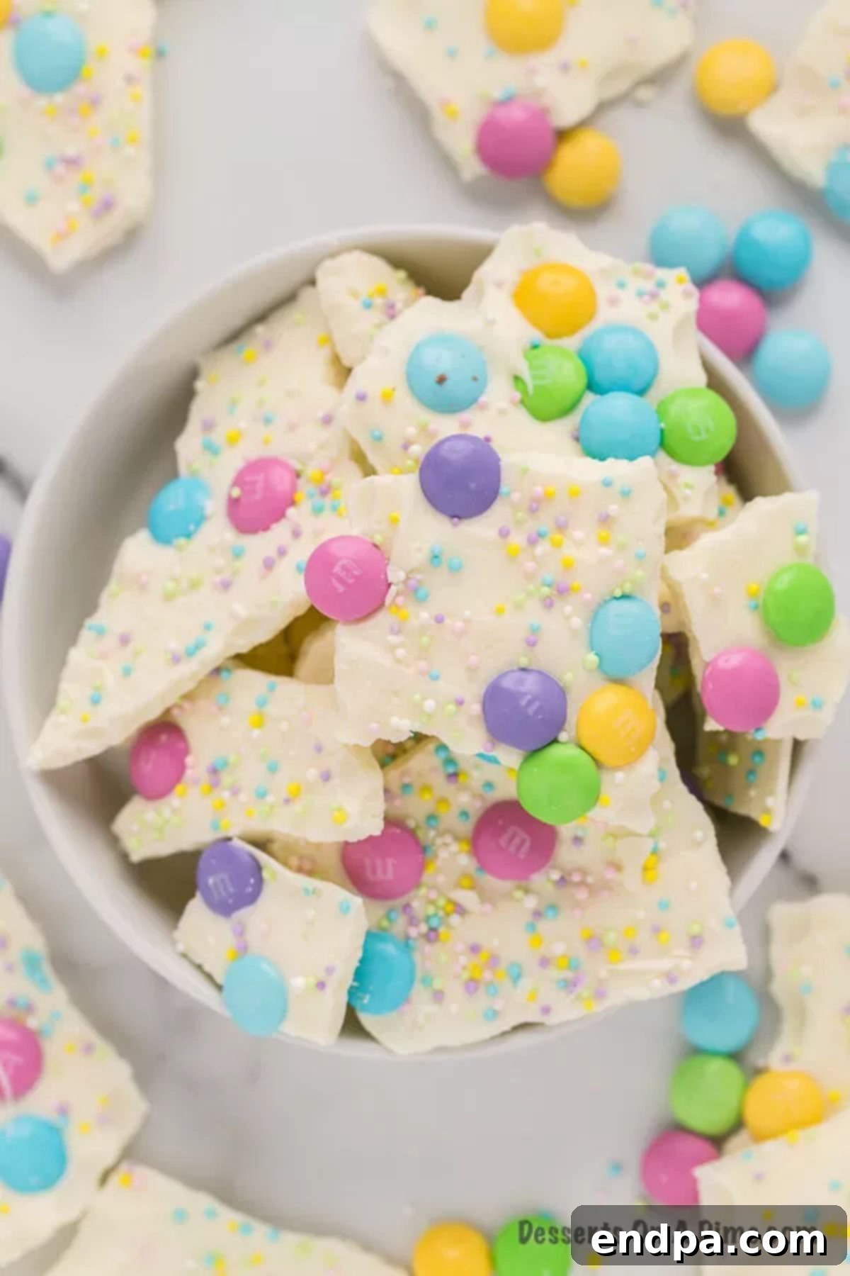 Close up image of Easter White Chocolate Bark with spring color candy and sprinkles. 