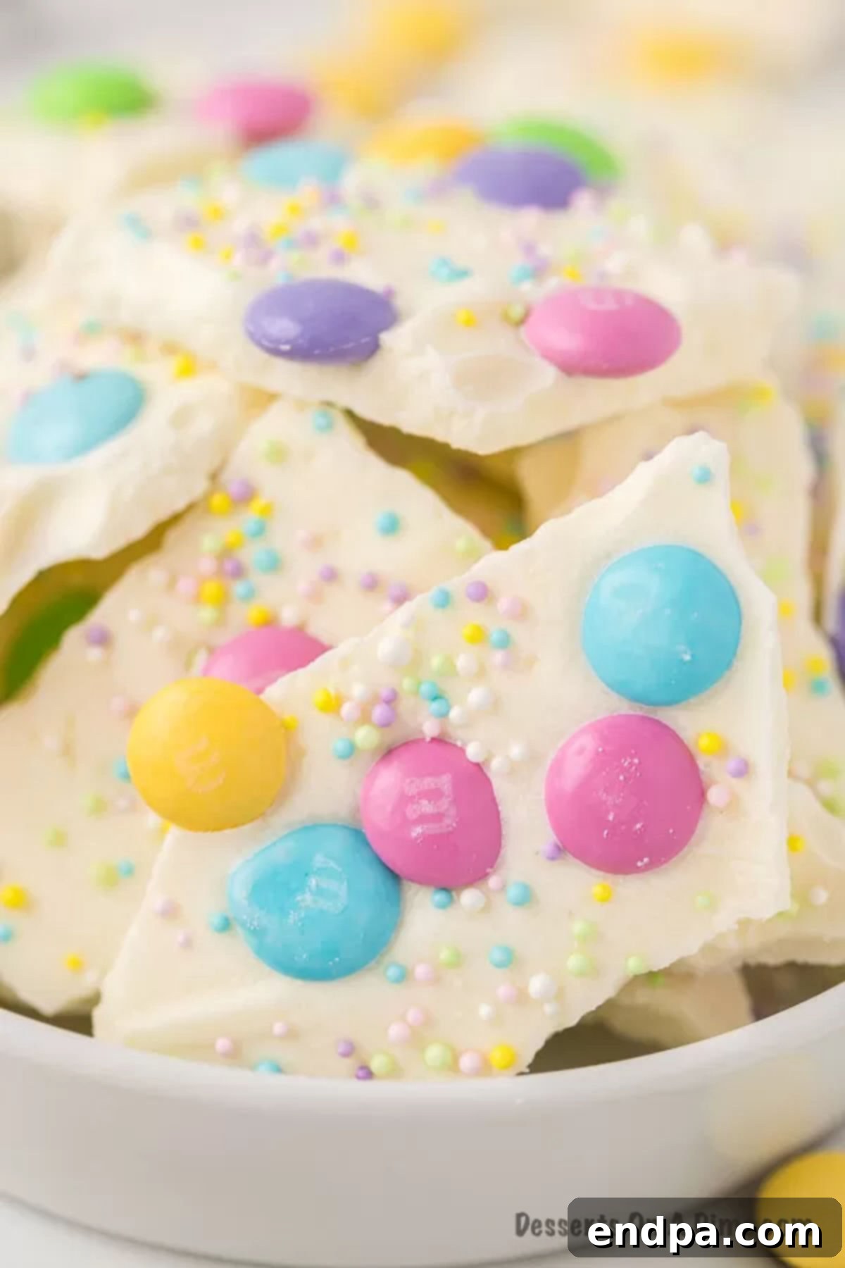 Close up image of Easter White Chocolate Bark with spring color candy and sprinkles. 