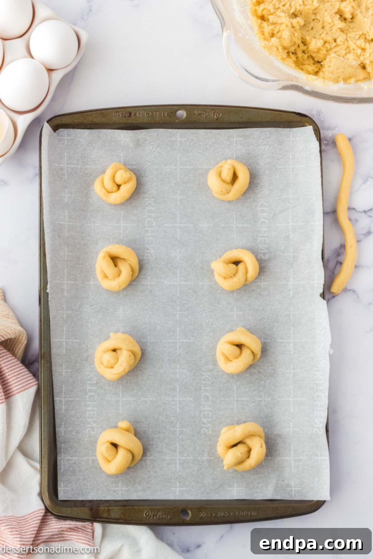 Dough in knots on baking sheet. 