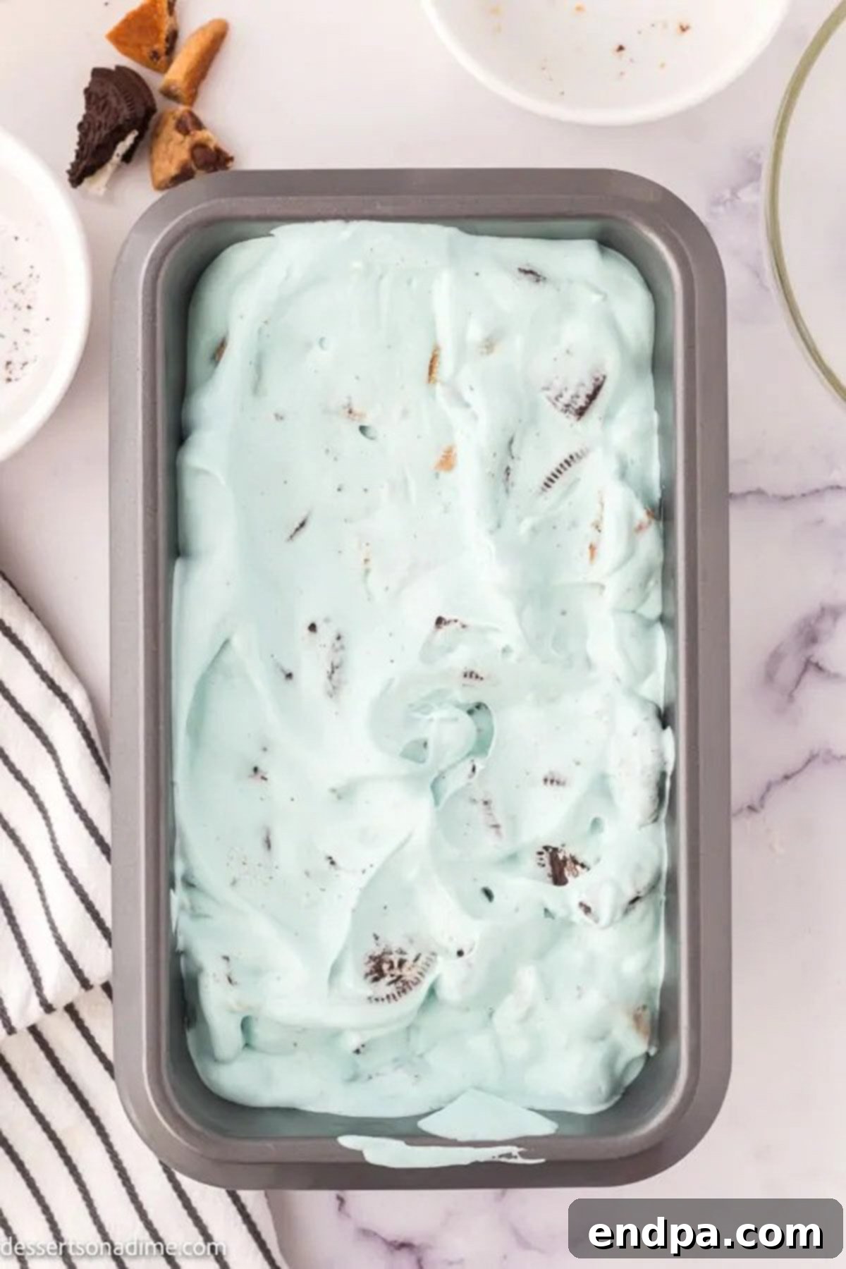 Ice cream mixture spread evenly into a loaf pan, ready for freezing.