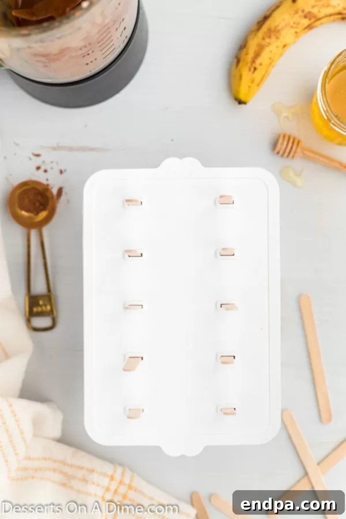 Popsicle sticks inserted into the filled molds, ready to go into the freezer.