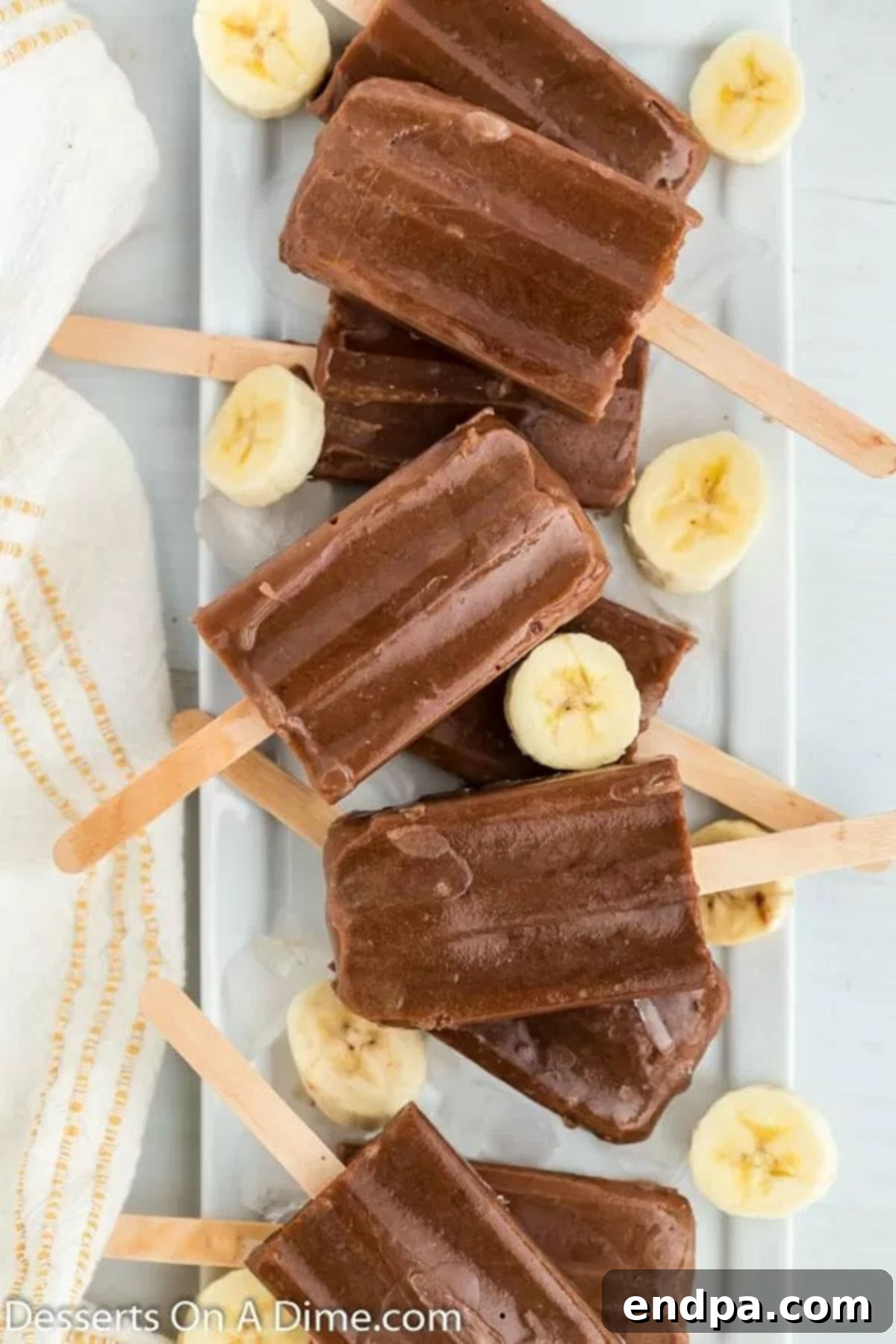 Stacked homemade chocolate banana popsicles, showcasing their creamy texture and delicious appeal.