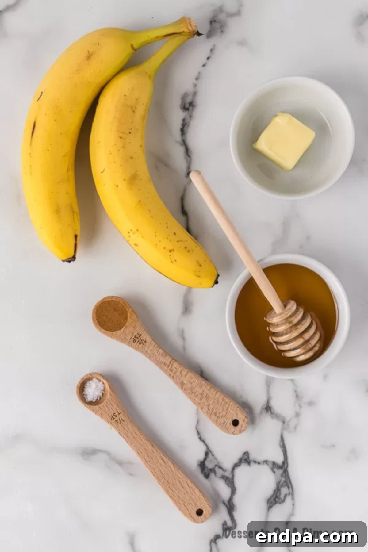 Sweet Fried Banana Delights 3 Ingredients for fried bananas: fresh bananas, a stick of butter, a bottle of honey, and a shaker of cinnamon.