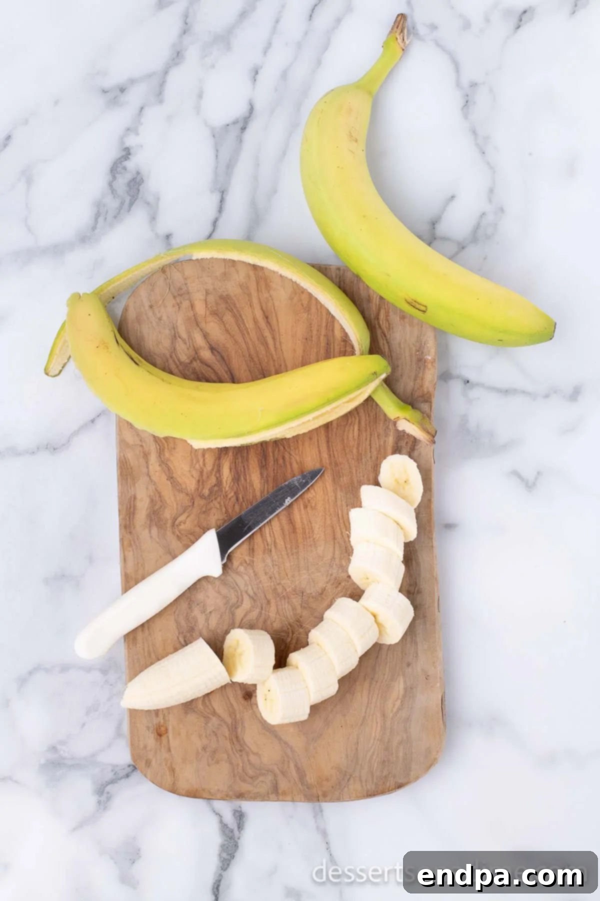 Sweet Fried Banana Delights 4 Sliced bananas on a cutting board, ready for frying.