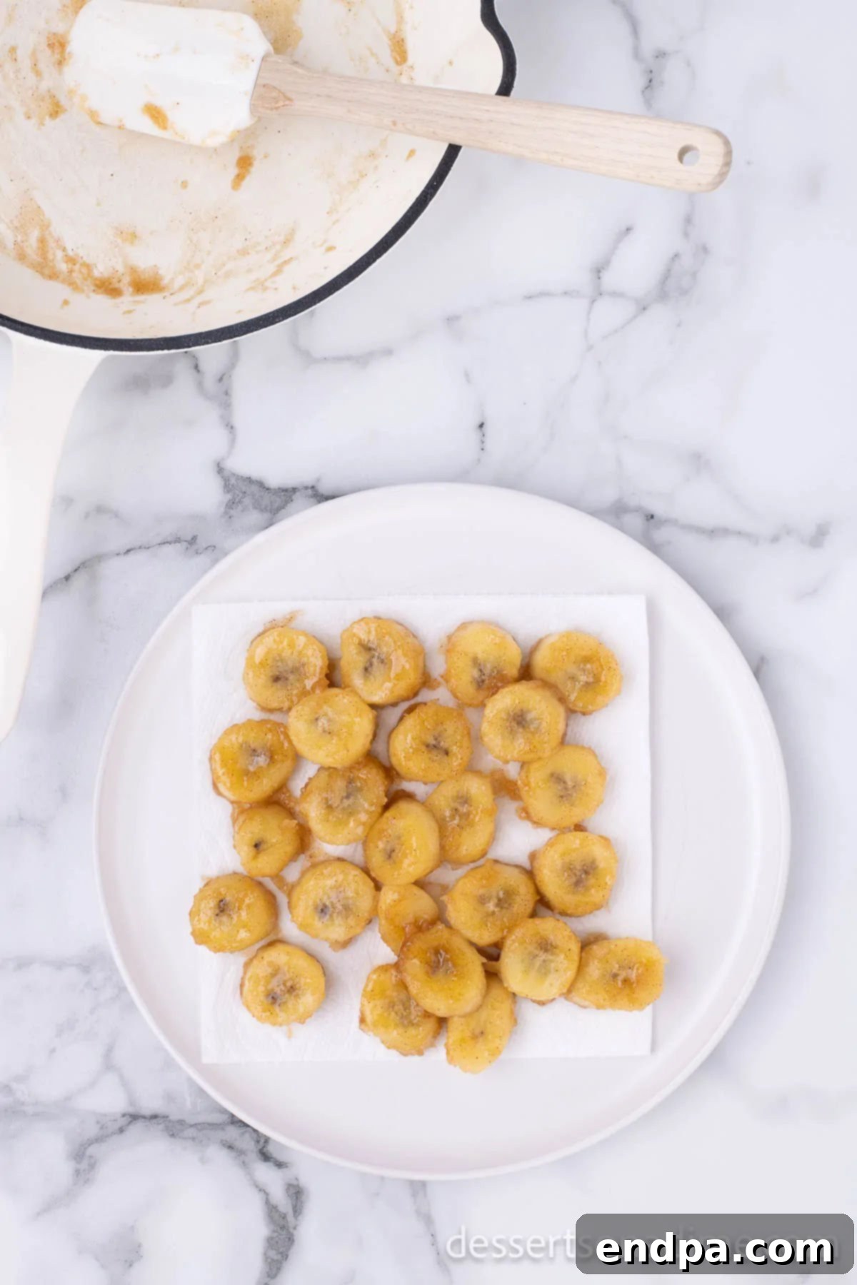 Sweet Fried Banana Delights 7 Cooked fried bananas neatly arranged on a white plate.