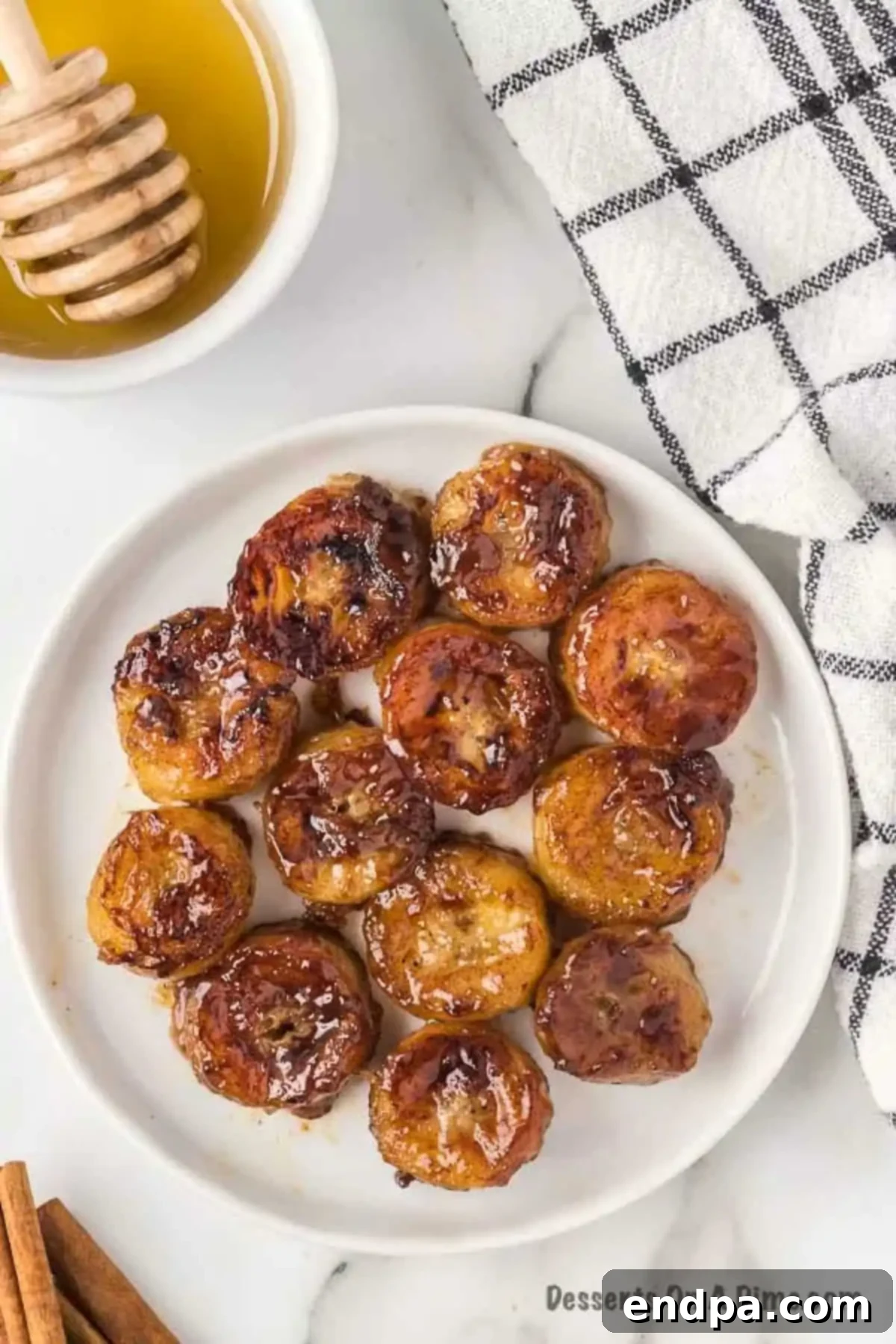Sweet Fried Banana Delights 8 Close up photo of fried bananas on a white plate, ready to be served.
