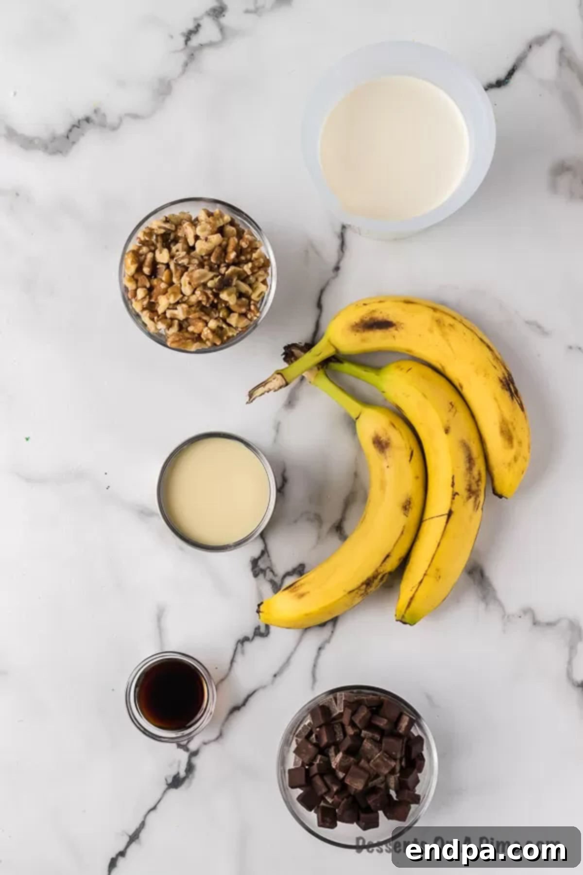 Banana Nut Fudge Frenzy 3 Ingredients for chunky monkey ice cream - heavy whipping cream, sweetened condensed milk, vanilla, and ripe bananas in a bowl.