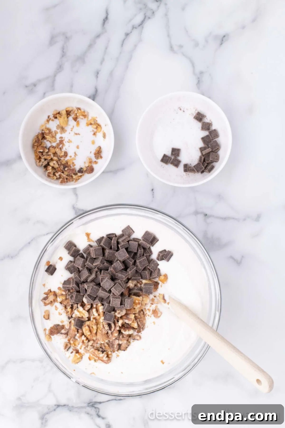 Banana Nut Fudge Frenzy 7 Mixing bowl with chocolate and walnuts added to ice cream mixture.