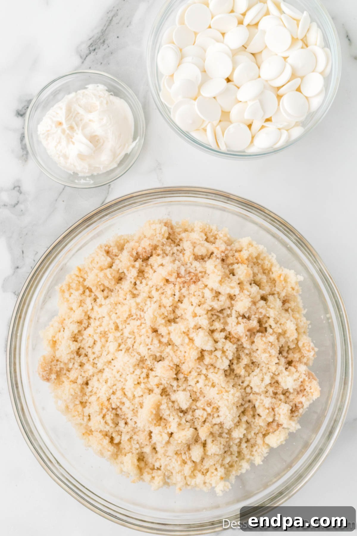 Cake crumbled into fine pieces in a large mixing bowl.