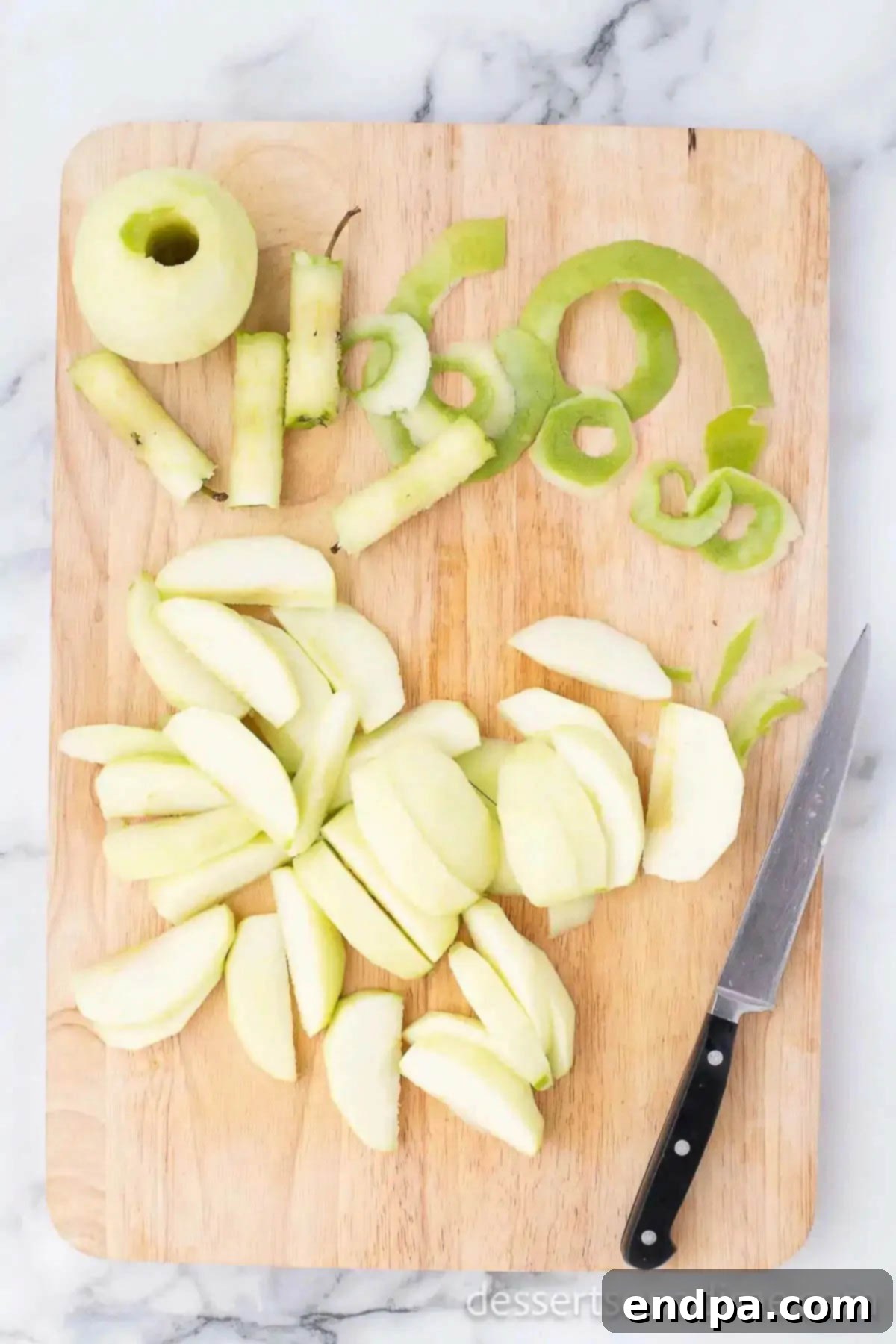 Apple slices on a cutting board, ready for cooking.