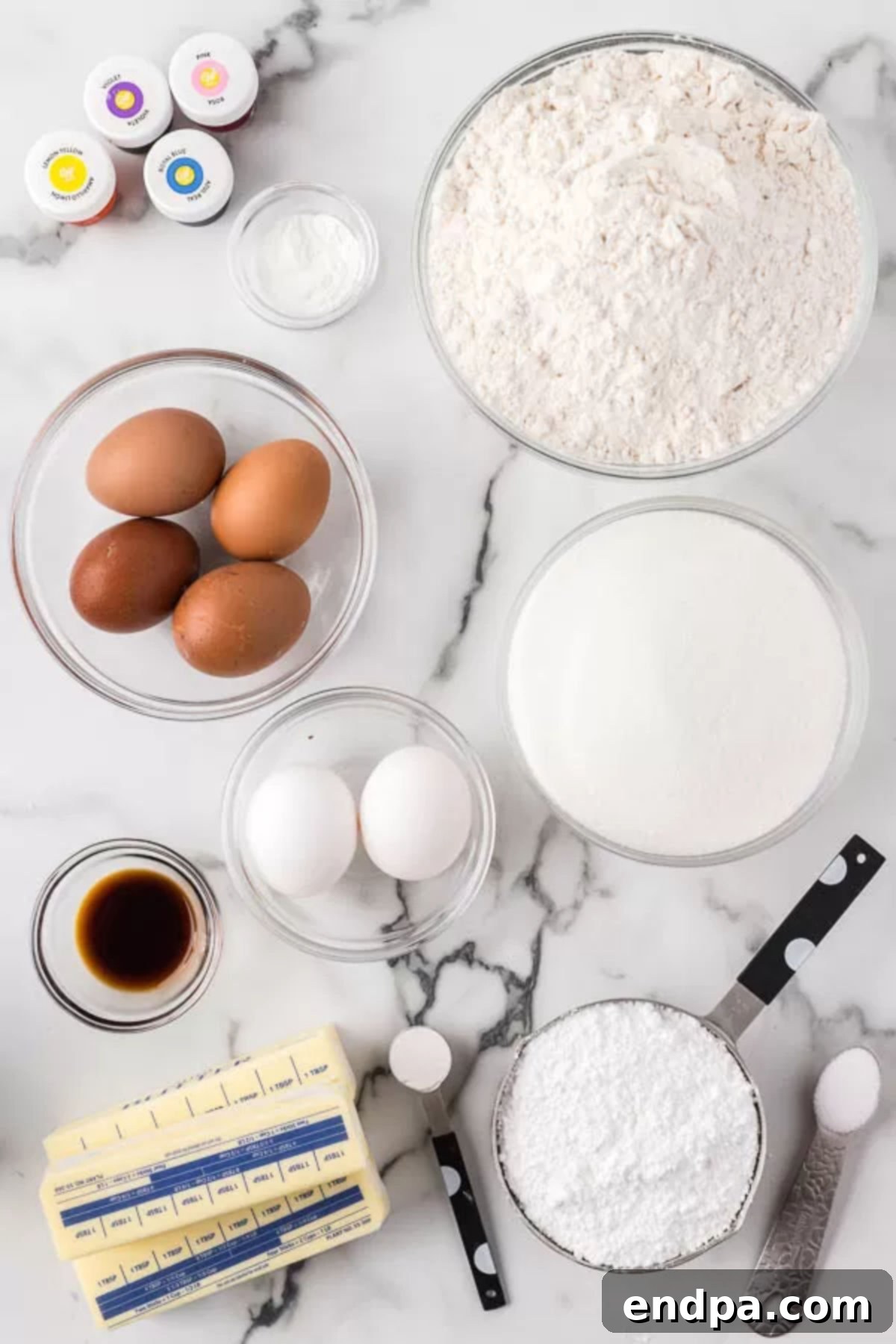 Ingredients for recipe - flour, butter, eggs, vanilla extract, egg whites, powdered sugar, cream of tartar, gel food coloring. 