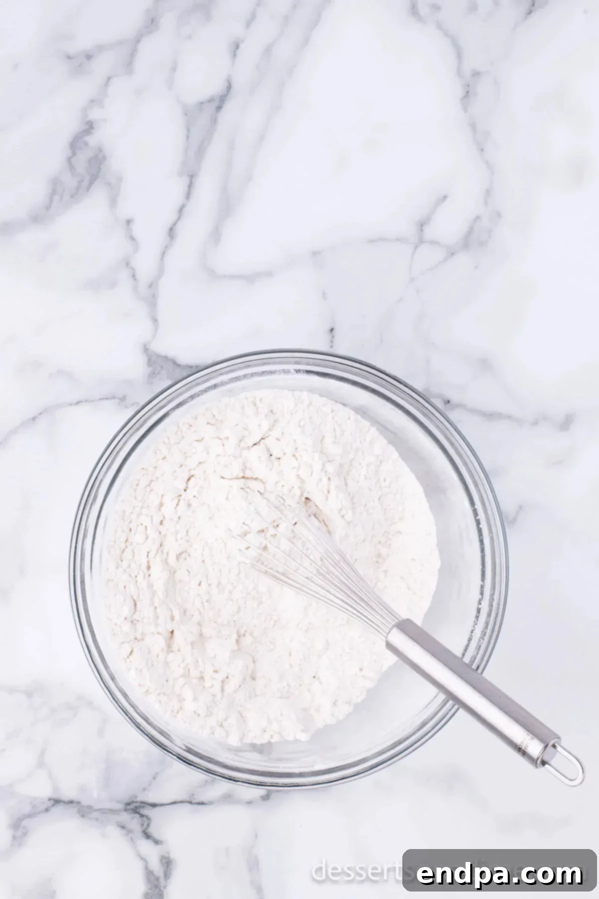 Dry ingredients combined together in a mixing bowl. 