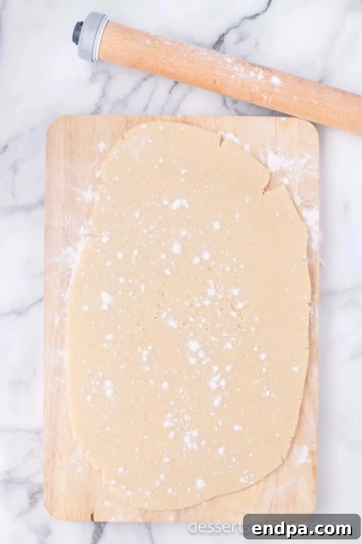 Dough rolled out and topped with flour. 