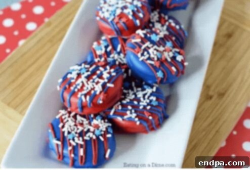 4th of July Chocolate Covered Oreos decorated with red and blue candy melts and sprinkles.