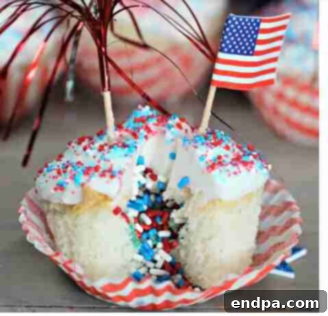 A cupcake decorated for the 4th of July with sprinkles on top.