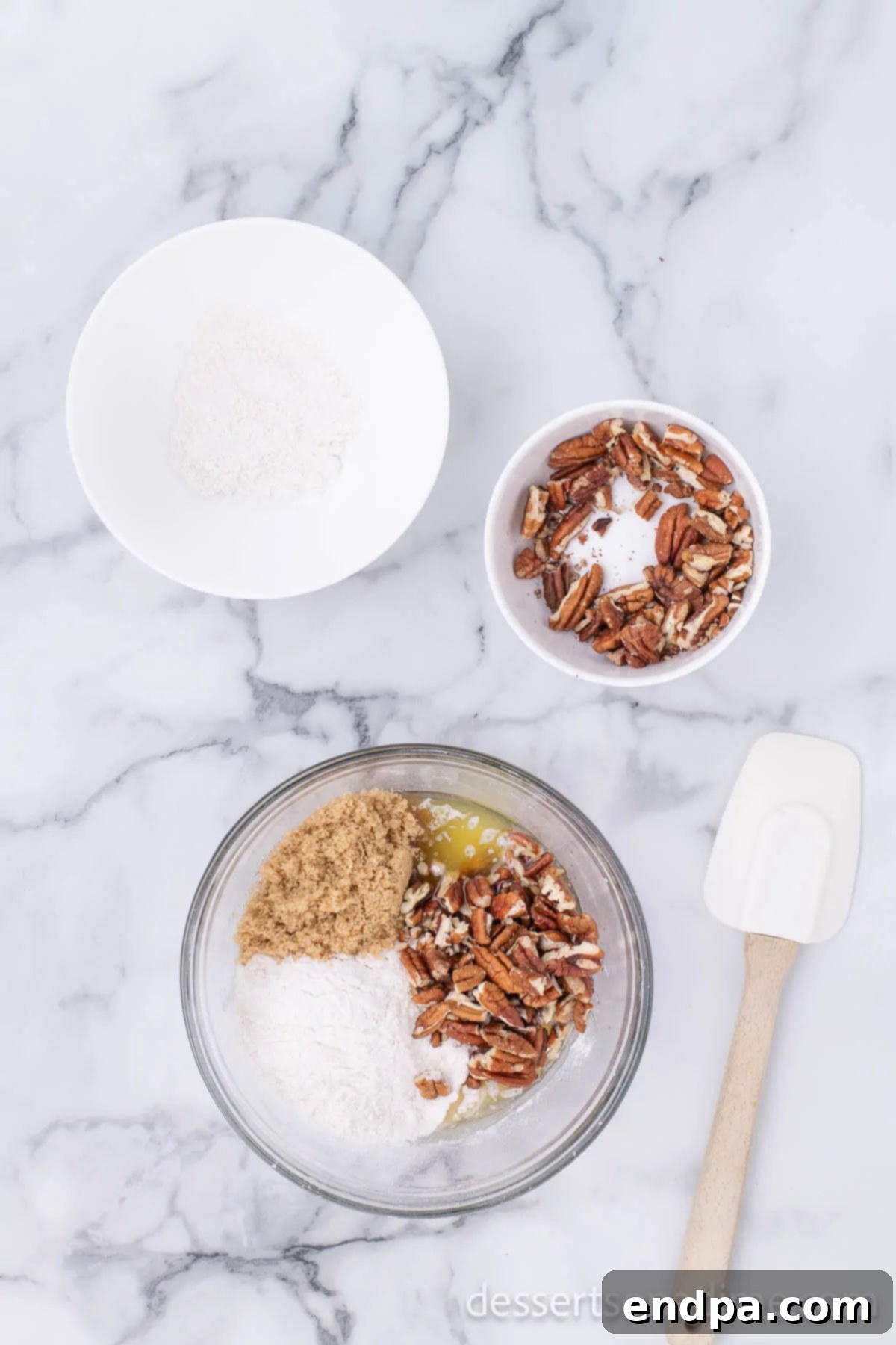 A mixing bowl filled with flour, brown sugar, finely chopped pecans, and melted butter, being stirred together to form the pie crust mixture.
