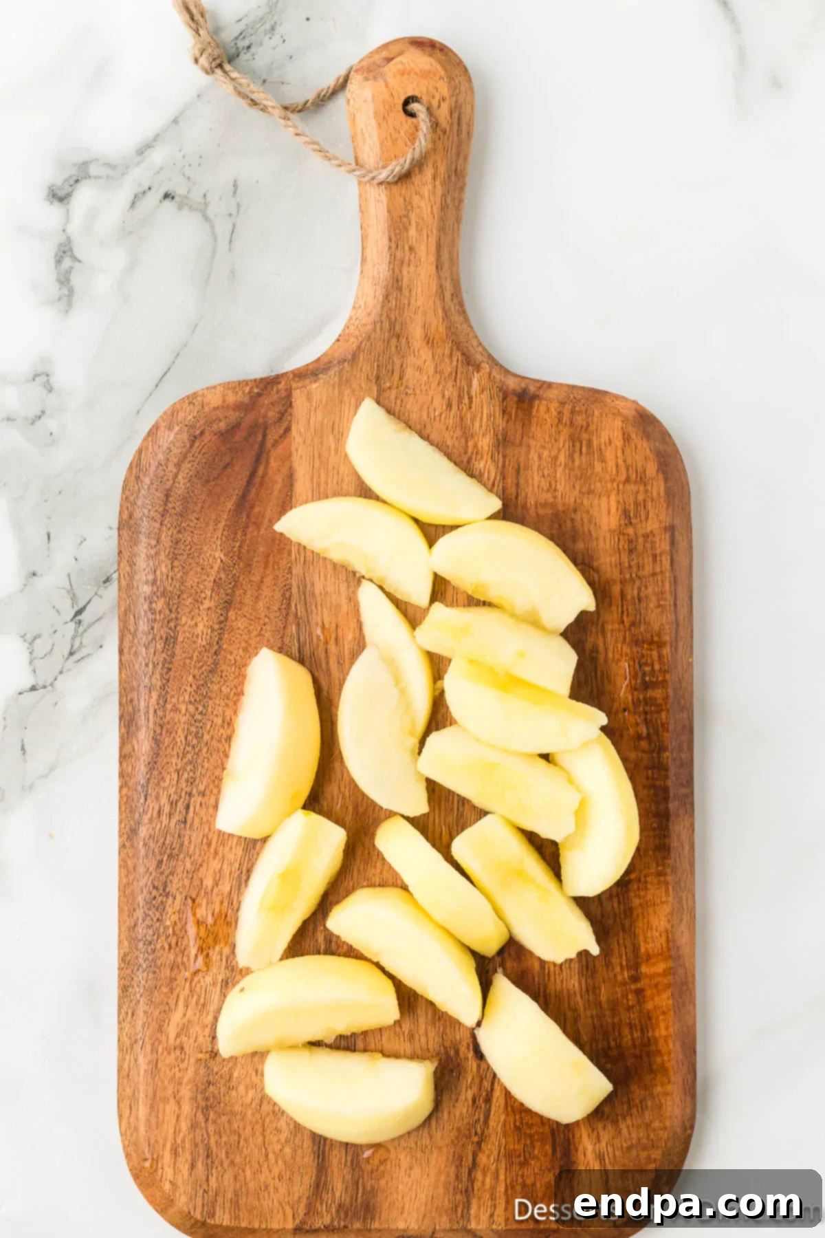 Golden Air Fryer Apple Slices 4 Sliced apples on cutting board.