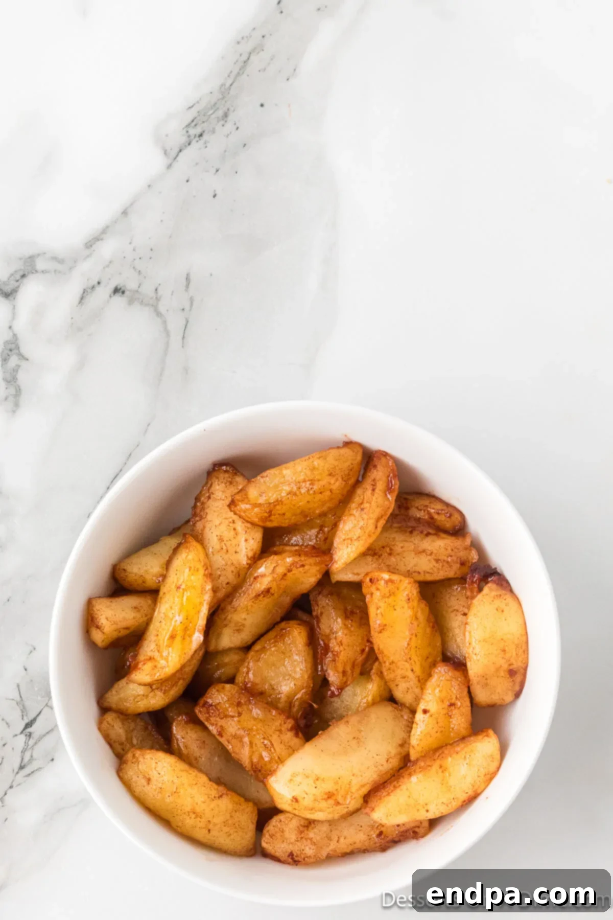 Golden Air Fryer Apple Slices 7 Apples in a bowl ready to serve.