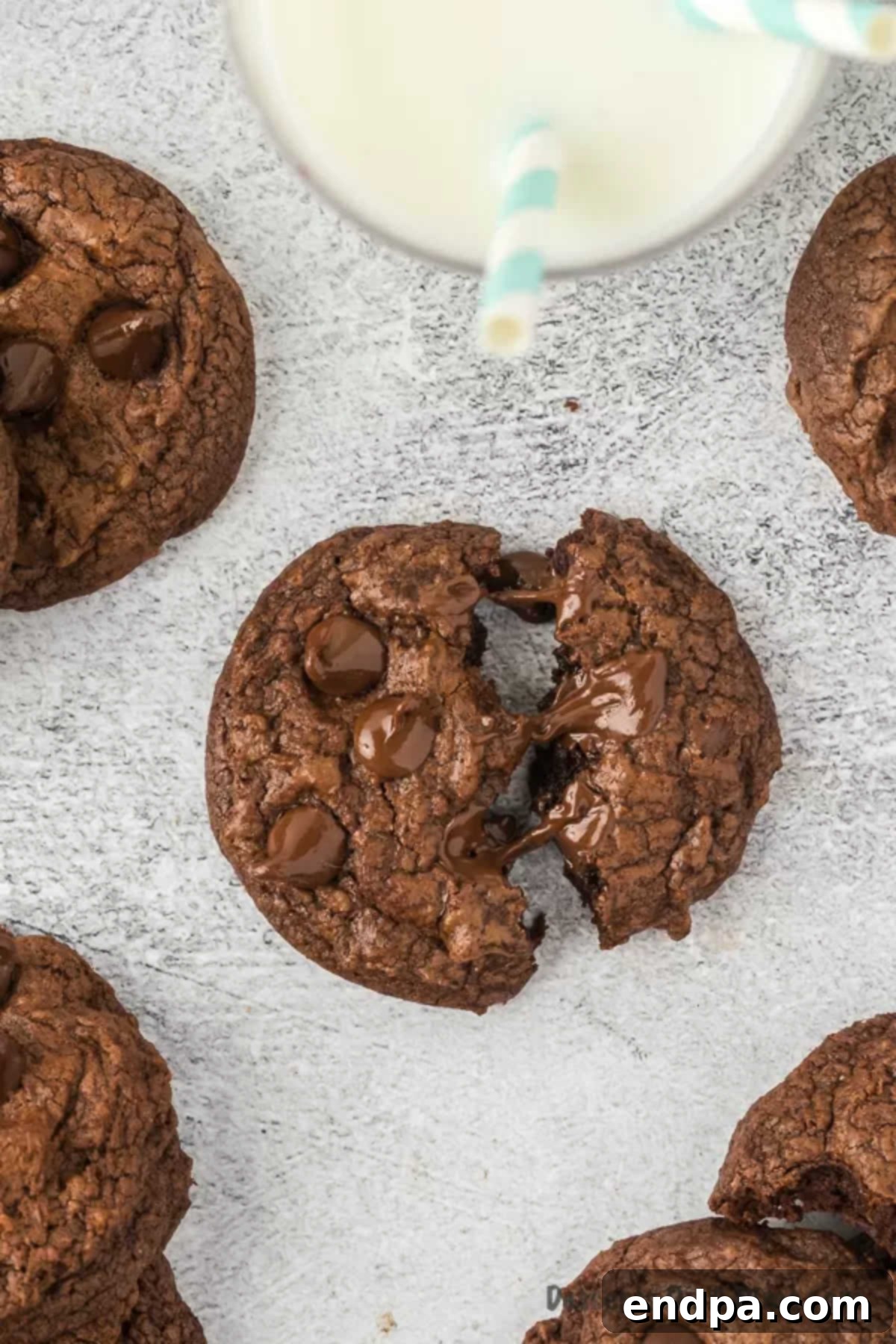 A delicious brownie cookie broken into pieces, revealing its soft, fudgy interior.