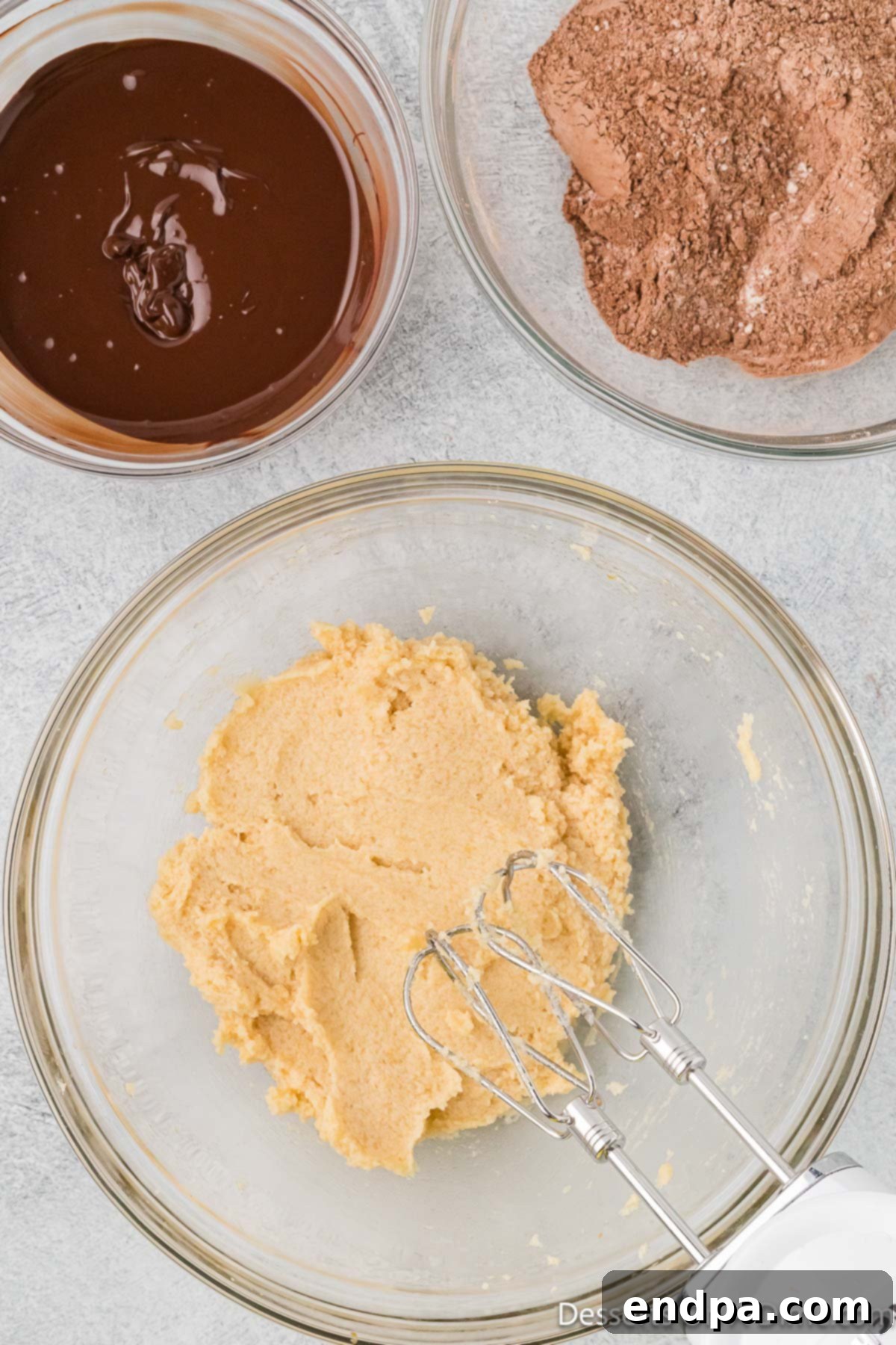 Softened butter and sugars creamed together in a mixing bowl until light and fluffy.