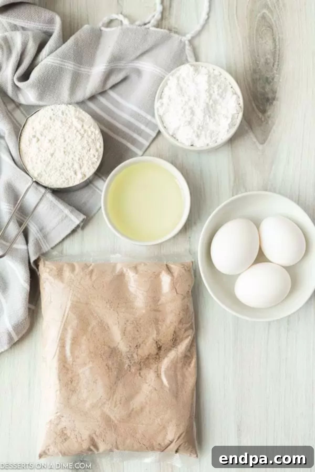 Ingredients for Brownie Mix Cookies recipe - brownie mix, flour, eggs, vegetable oil, powdered sugar. 