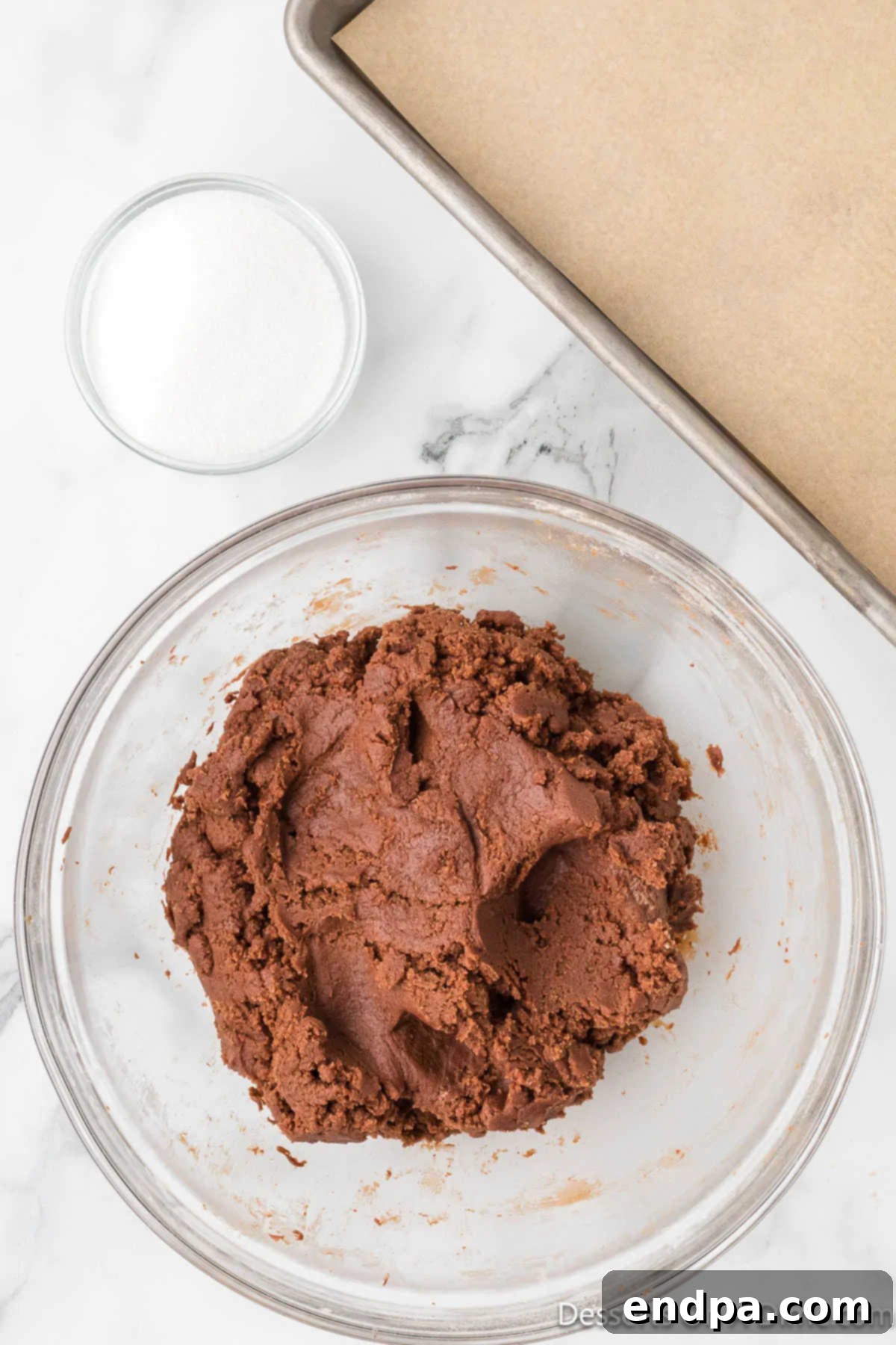 The chocolate cookie batter is now fully mixed and has a smooth, consistent texture.