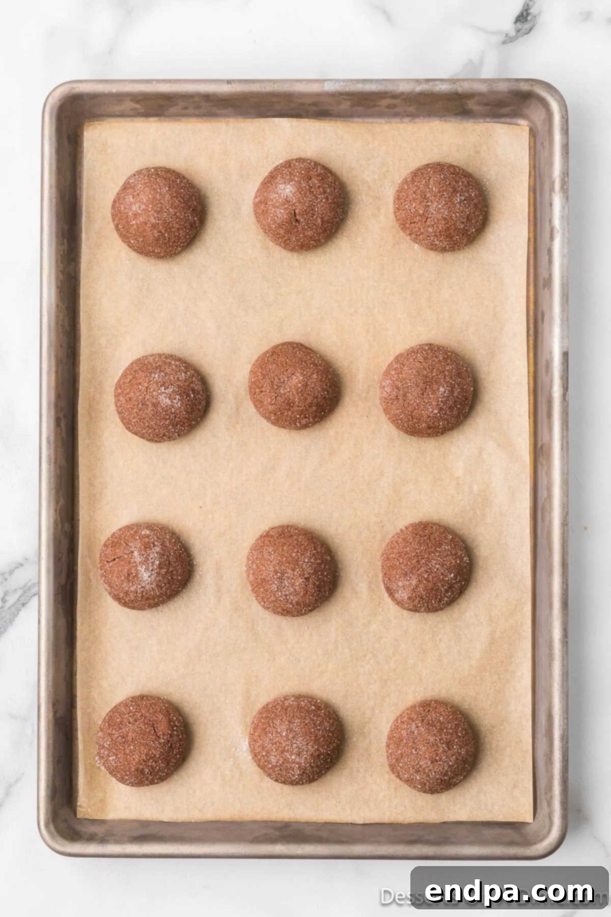 Baked chocolate kiss cookies, fresh out of the oven, with their edges set and centers still soft.