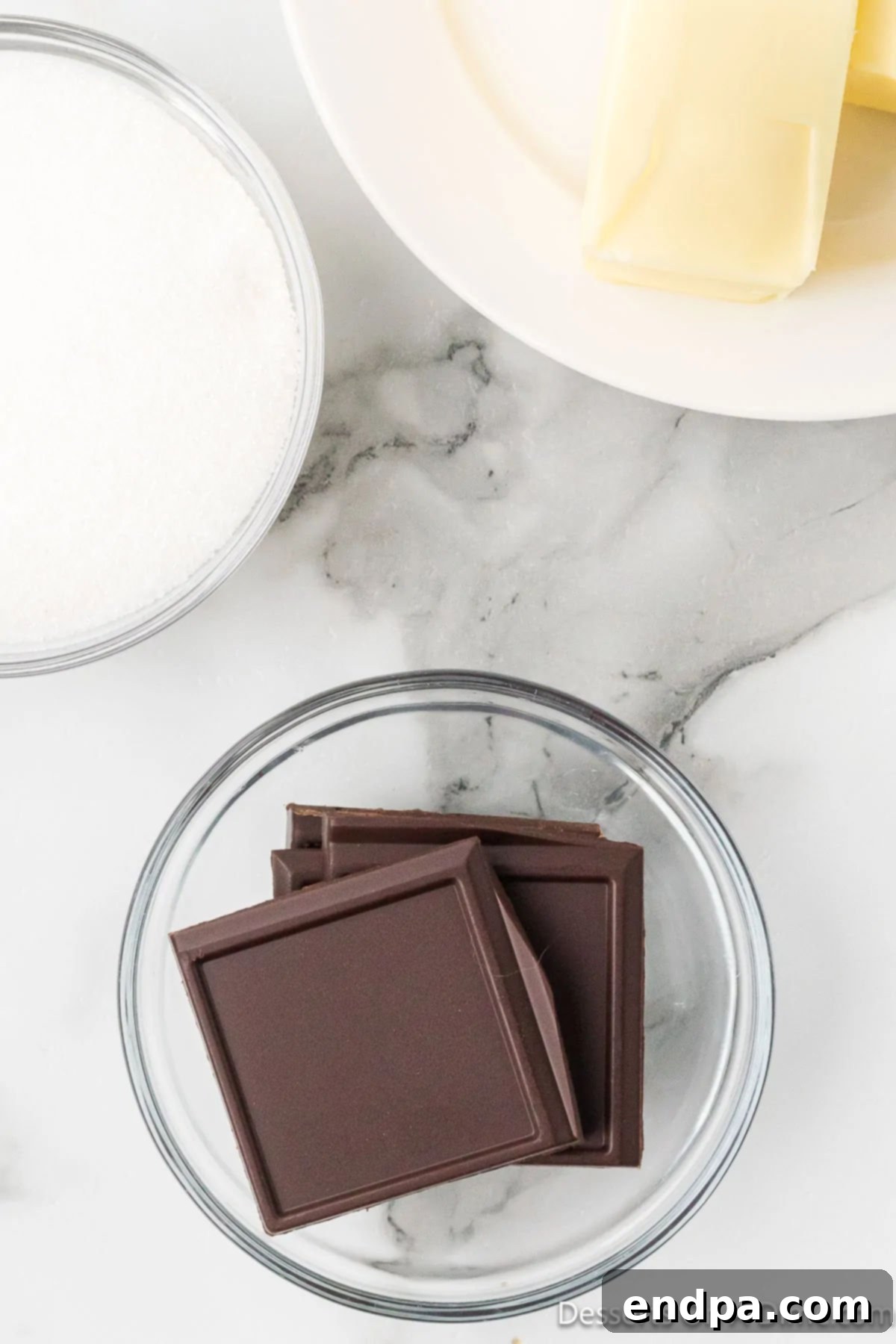 Semi-sweet chocolate squares in a microwave-safe bowl, ready to be melted.