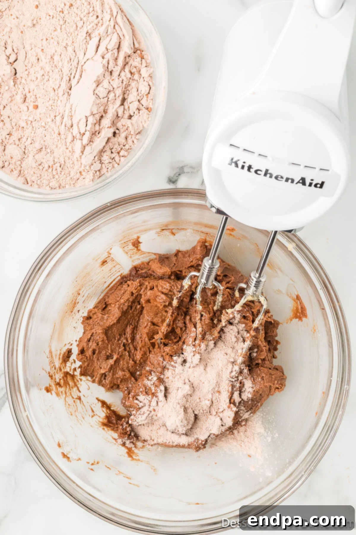 The wet and dry ingredients are brought together in a large mixing bowl, ready to be combined into dough.