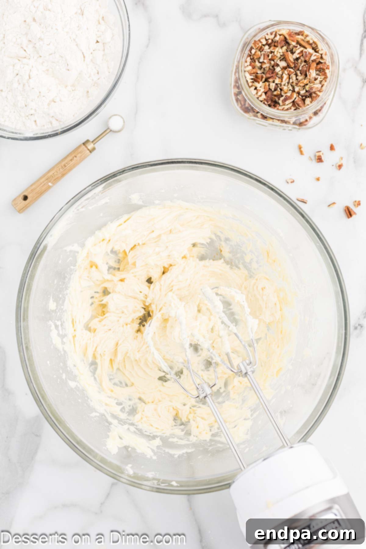 Powdered Sugar Dreams 5 Butter and sugar combined in a bowl with a mixer.