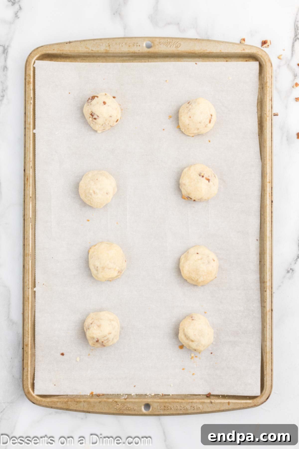 Powdered Sugar Dreams 9 Cookies baked and cooling on baking sheet.