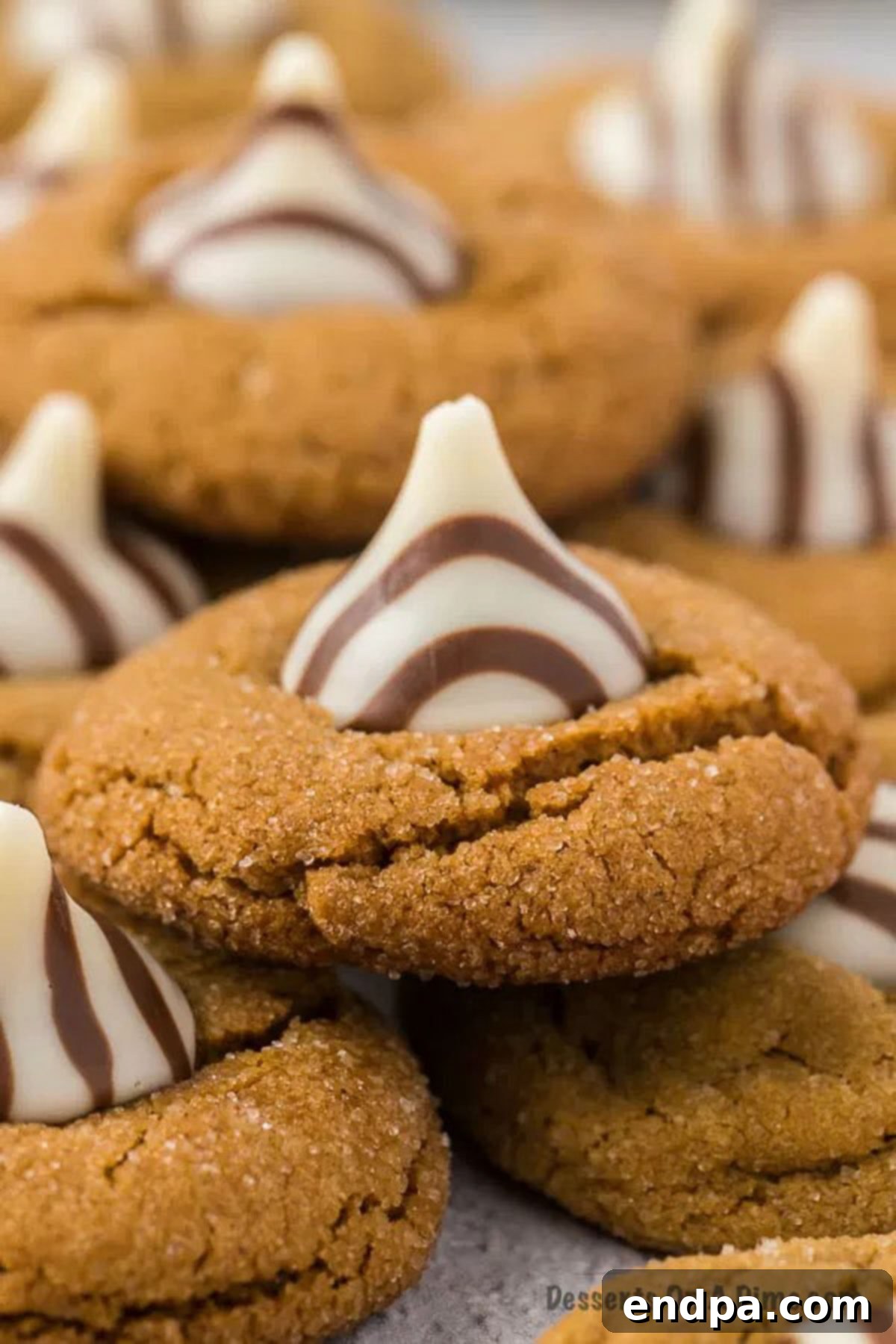 Gingerbread Kiss Cookies stacked together, showcasing their festive appeal.