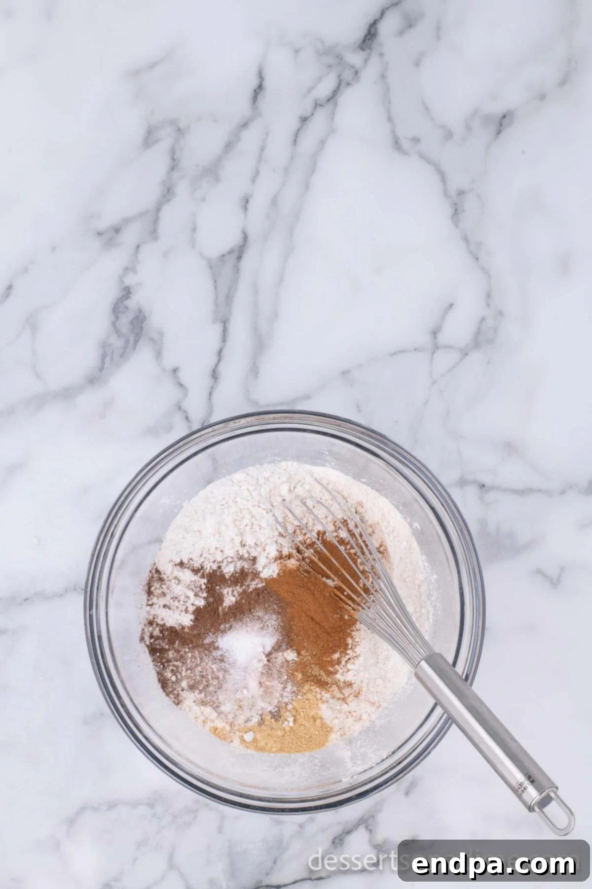 Dry ingredients, including flour and spices, whisked together in a separate bowl.