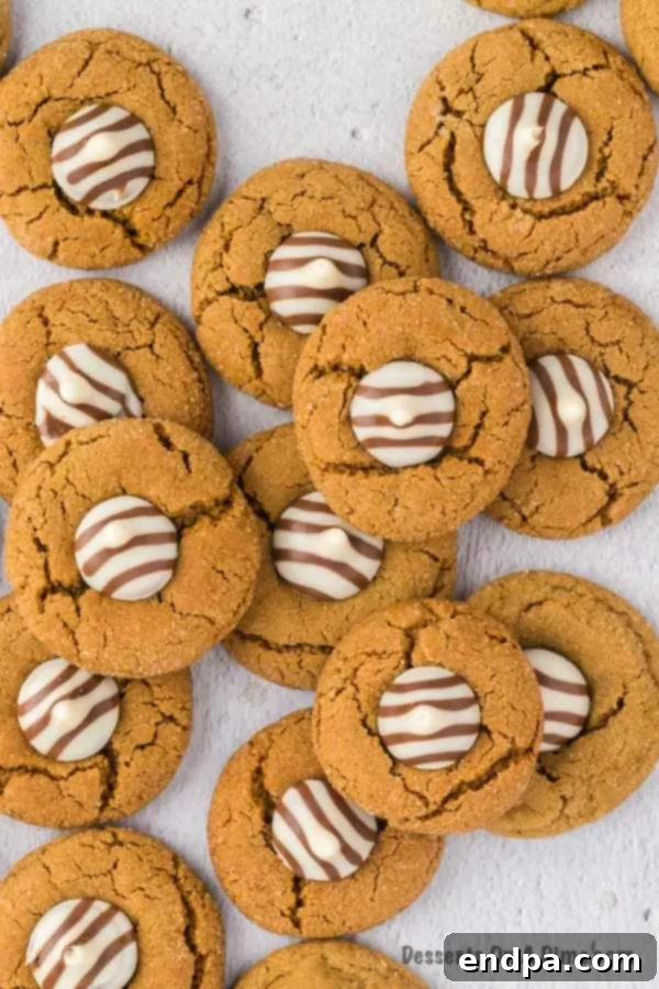 Finished Gingerbread Kiss Cookies cooling on a wire rack, ready to be enjoyed.