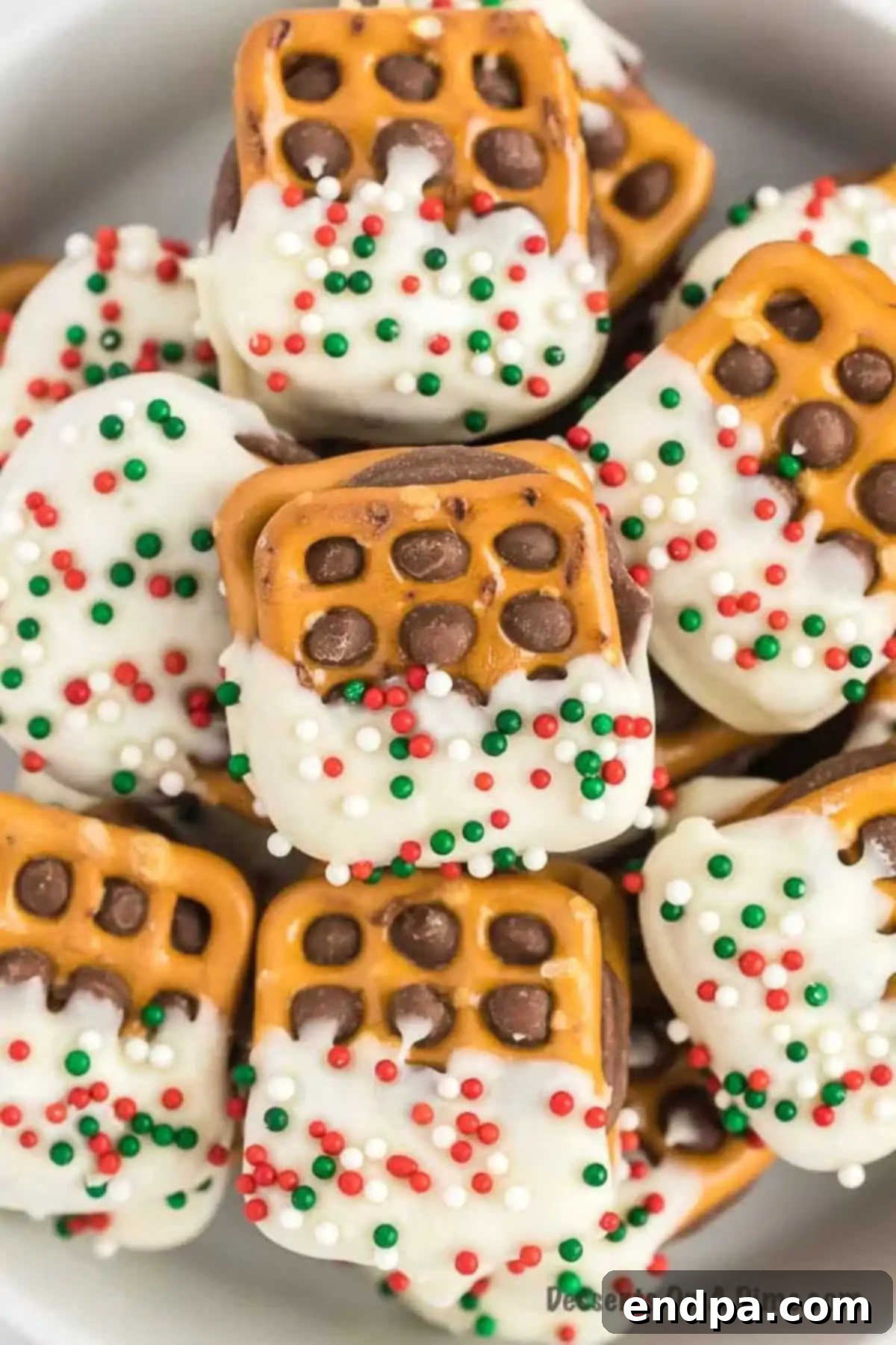 Rolo Pretzel Sandwiches stacked together, showcasing the gooey caramel and chocolate topping.