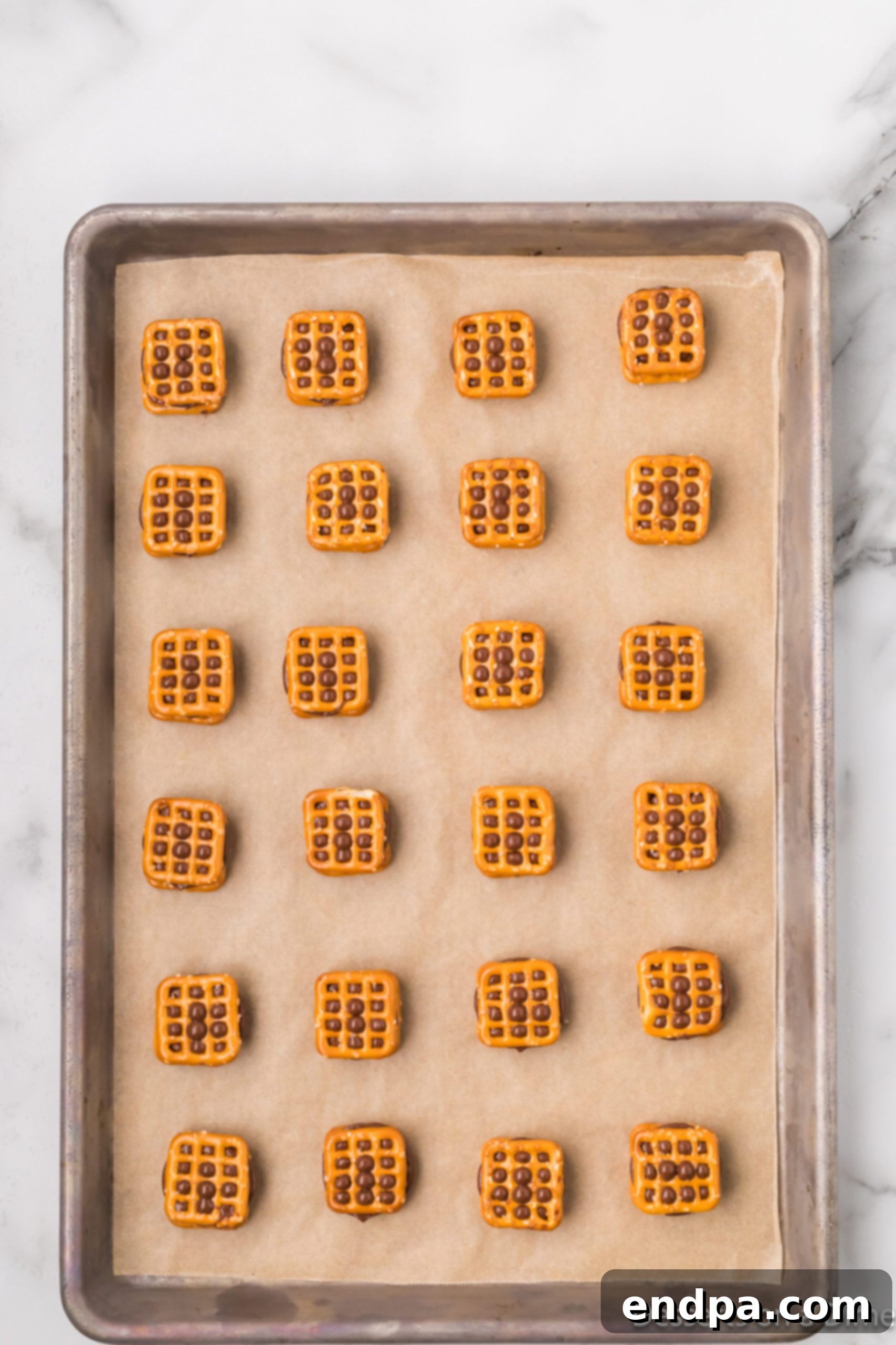 Another pretzel placed on top of the softened Rolo candy, forming a sandwich.