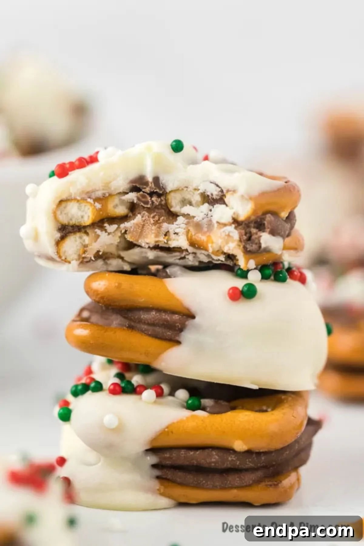 A close-up shot of multiple Rolo Pretzel Sandwiches, beautifully stacked and ready to be enjoyed.