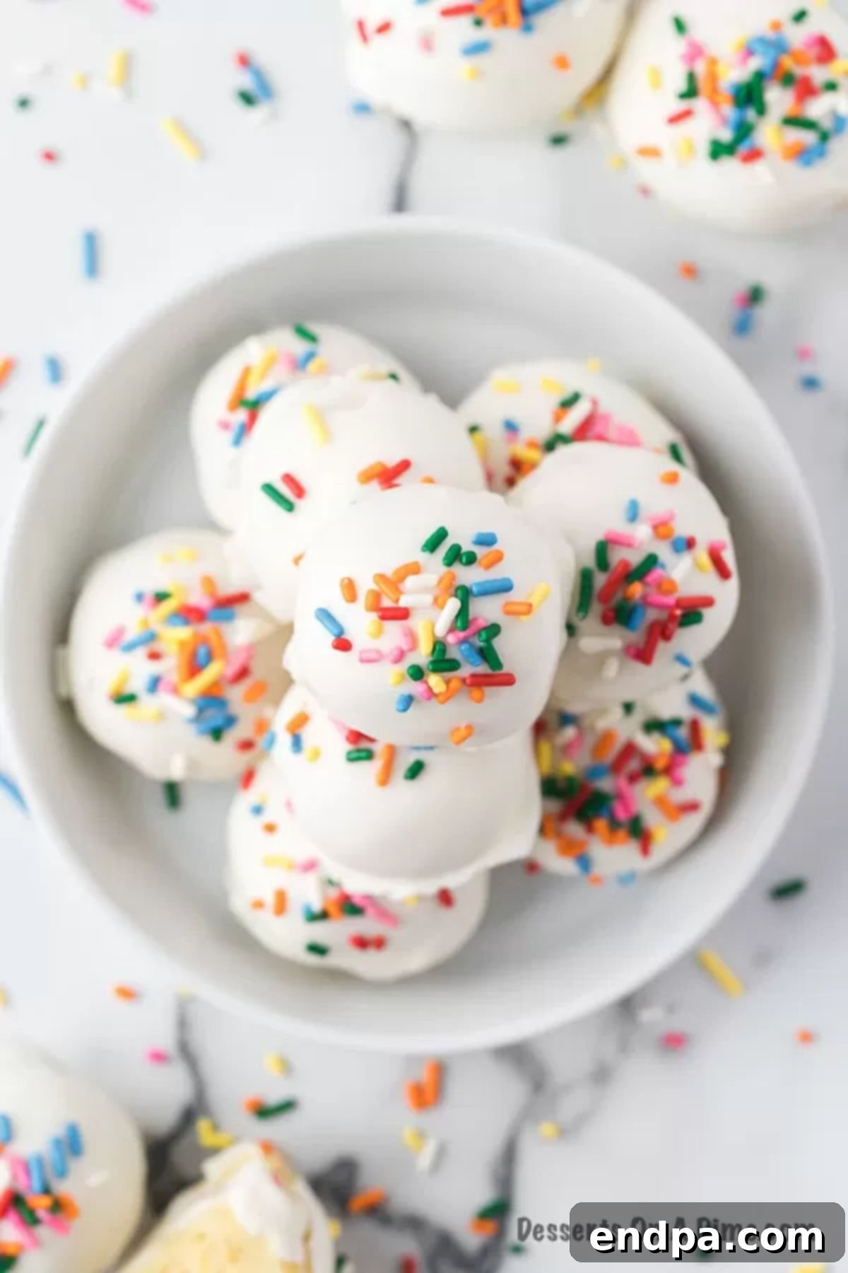 A bowl filled with finished vanilla cake balls, ready to be served.