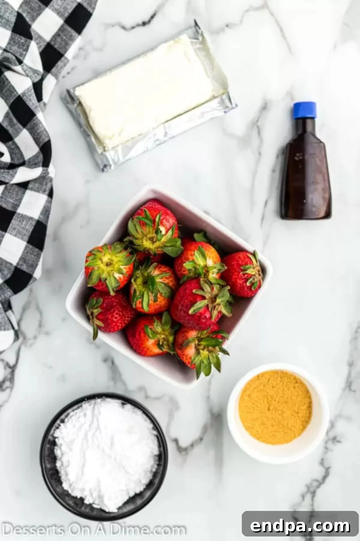 Ingredients for cheesecake stuffed strawberries: fresh large strawberries, softened cream cheese, powdered sugar, vanilla extract, and graham cracker crumbs.