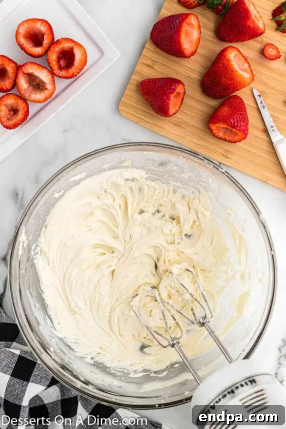 Creamy cheesecake filling in a mixing bowl, ready to be piped.
