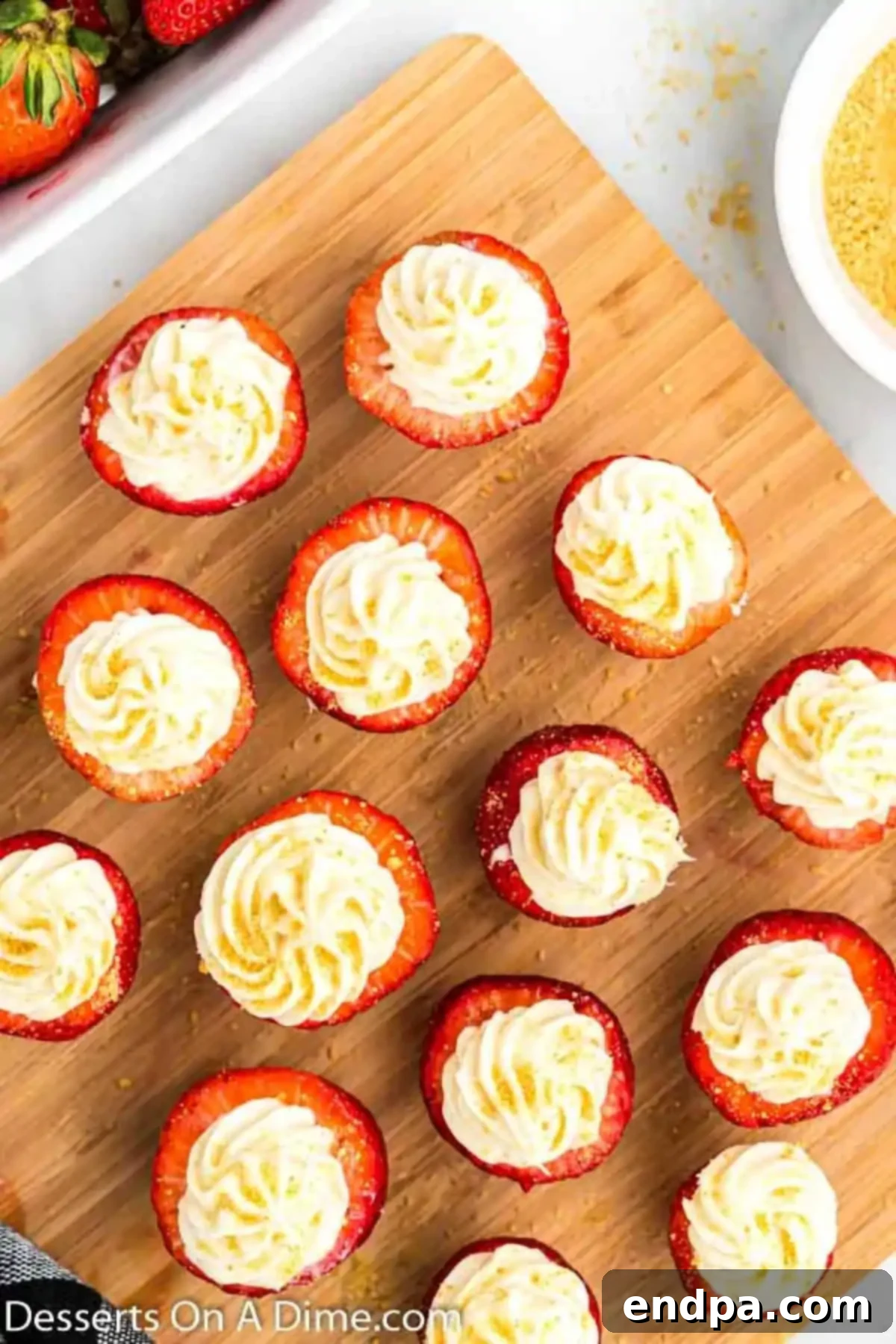 Finished cheesecake stuffed strawberries, topped with graham cracker crumbs and ready to serve.