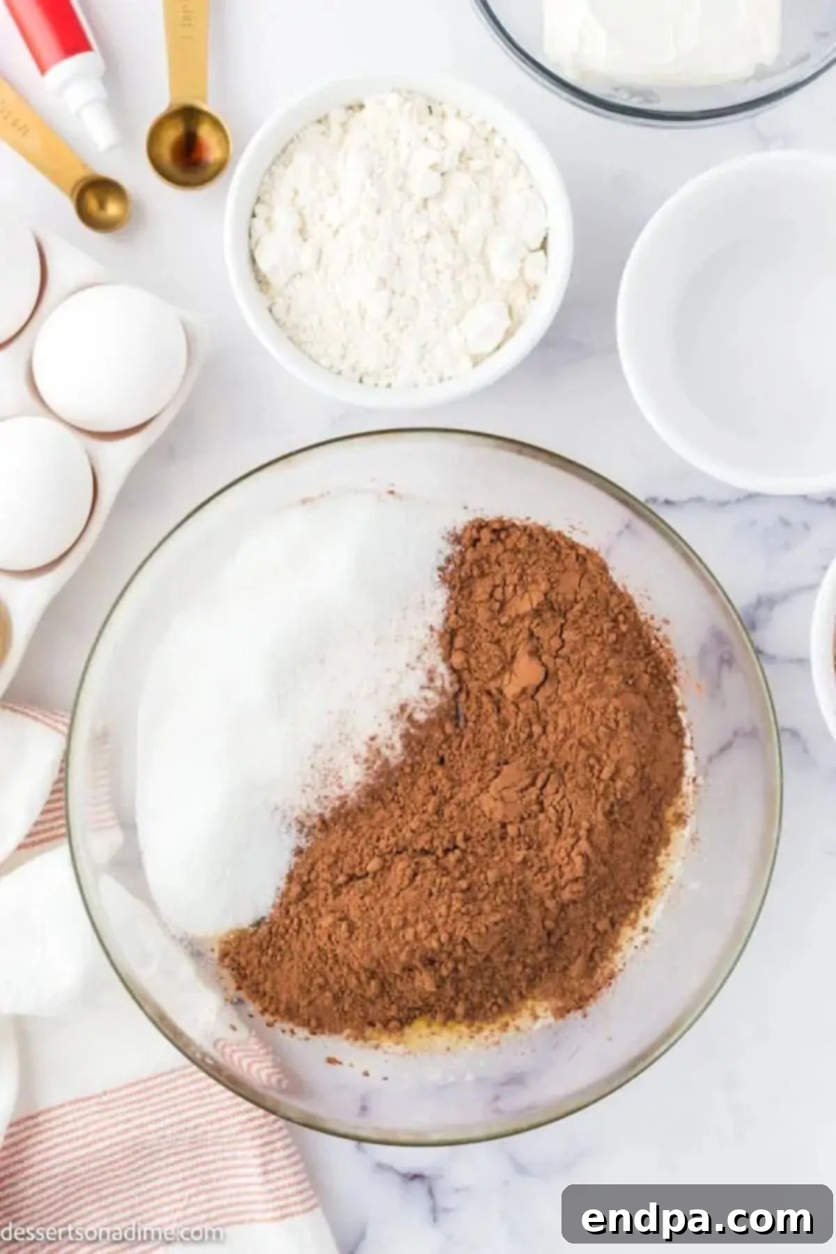 Swirled Red Velvet Cheesecake Brownies 4 Bowl of sugar, vanilla, and cocoa powder ready to be mixed.
