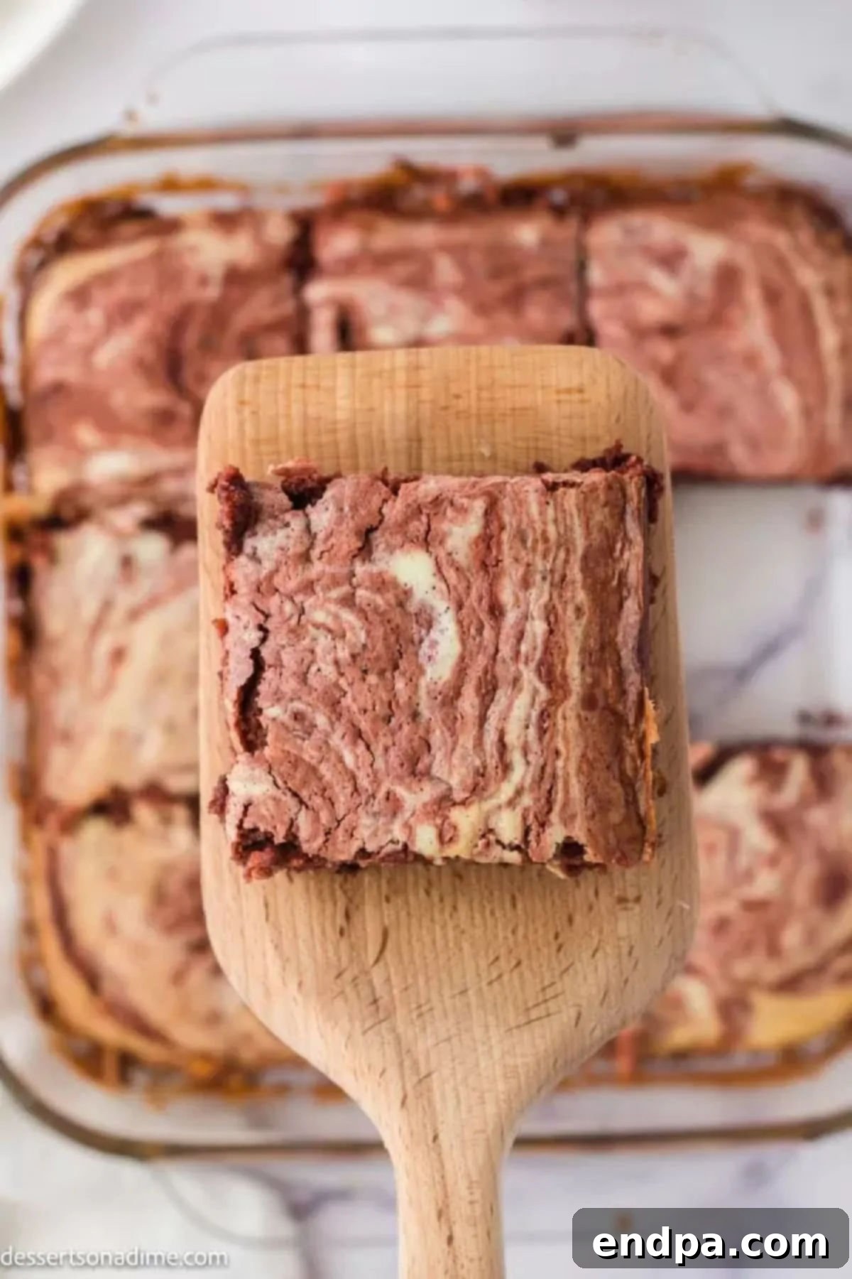 Swirled Red Velvet Cheesecake Brownies 10 Close-up photo of a single Red velvet cheesecake brownie, showing the intricate red and white swirls.
