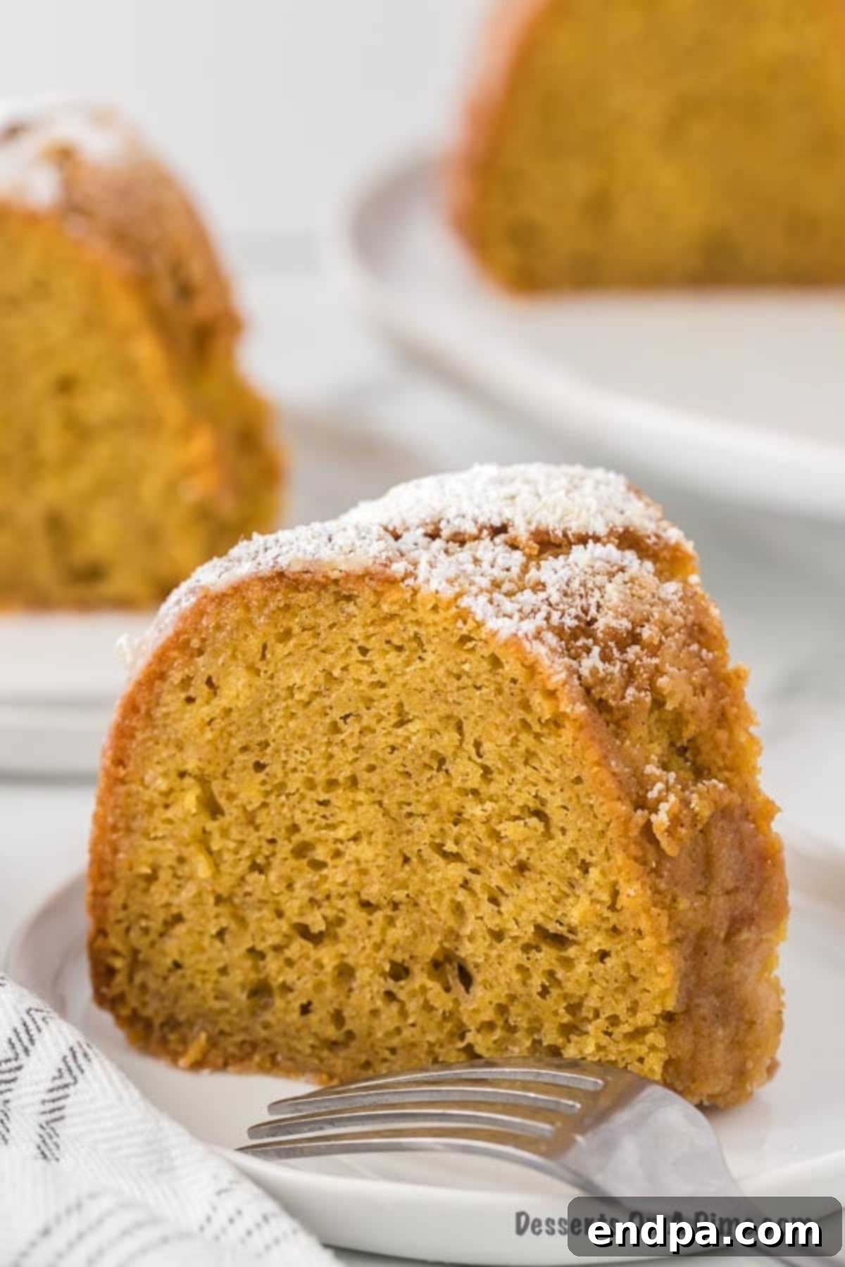 Unforgettable Craving Cake 2 A perfectly sliced piece of Crack Cake, showing its moist interior and glistening white wine glaze, ready to be served.